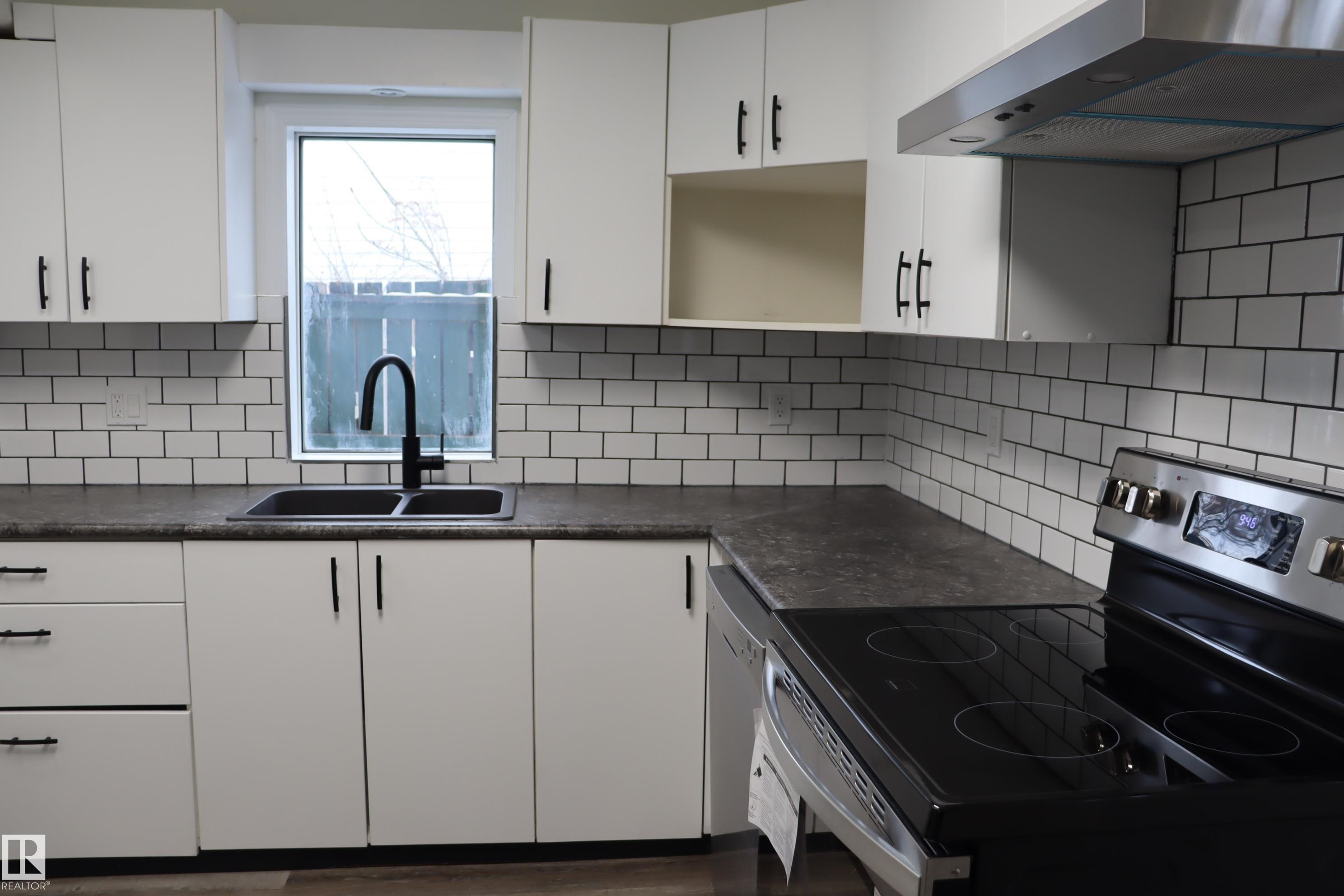 New sink and faucet - 4508 52 St., Wetaskiwin, AB - Indoor Photo Showing Kitchen With Double Sink
