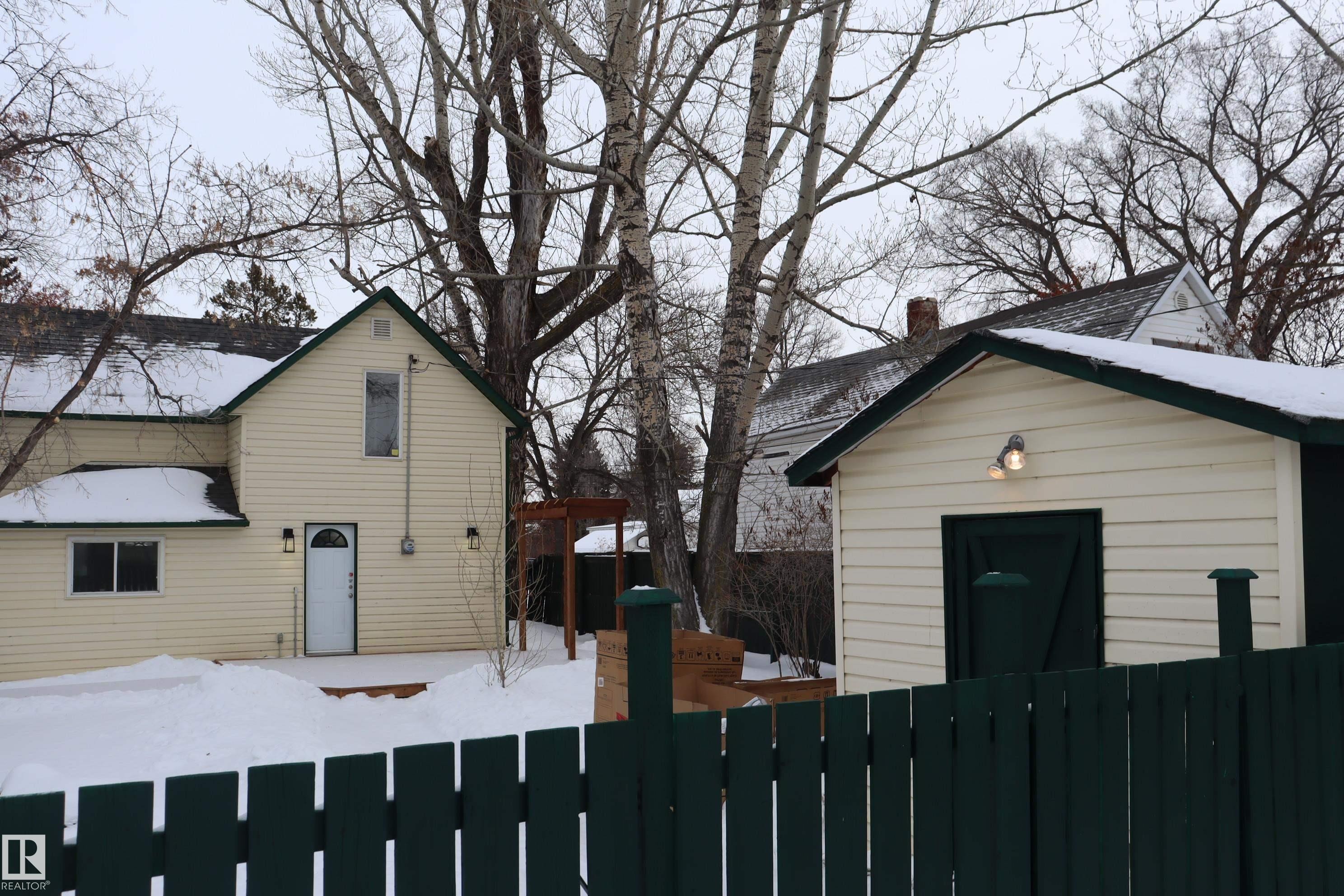 Fenced yard with large storage shed with power. - 4508 52 St., Wetaskiwin, AB - Outdoor With Exterior