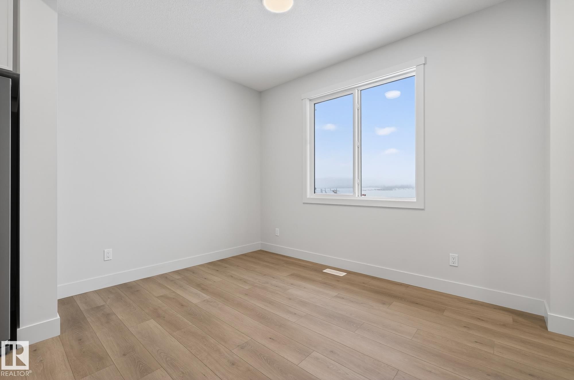 Spare room featuring light wood finished floors and baseboards - 119 Brickyard Drive, Stony Plain, AB - Indoor Photo Showing Other Room