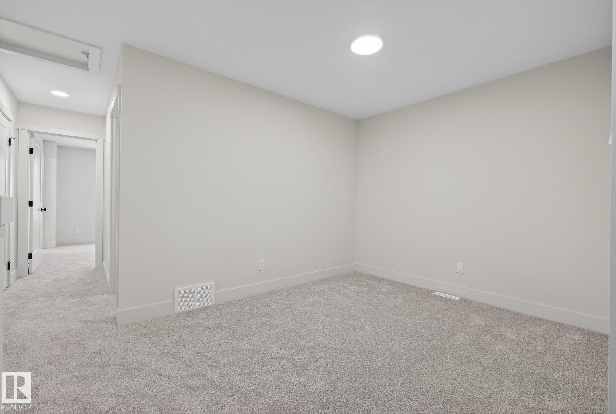 Empty room featuring carpet floors and baseboards - 119 Brickyard Drive, Stony Plain, AB - Indoor Photo Showing Other Room