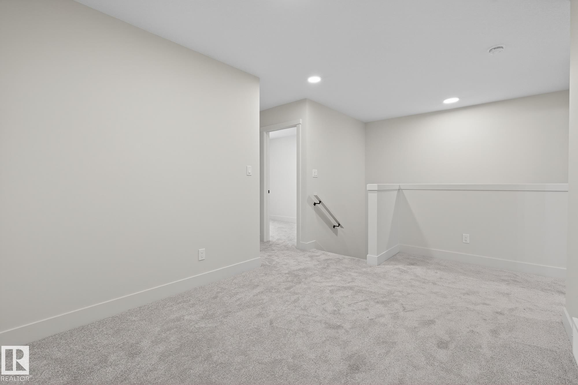 Unfurnished room with light colored carpet and recessed lighting - 119 Brickyard Drive, Stony Plain, AB - Indoor Photo Showing Other Room
