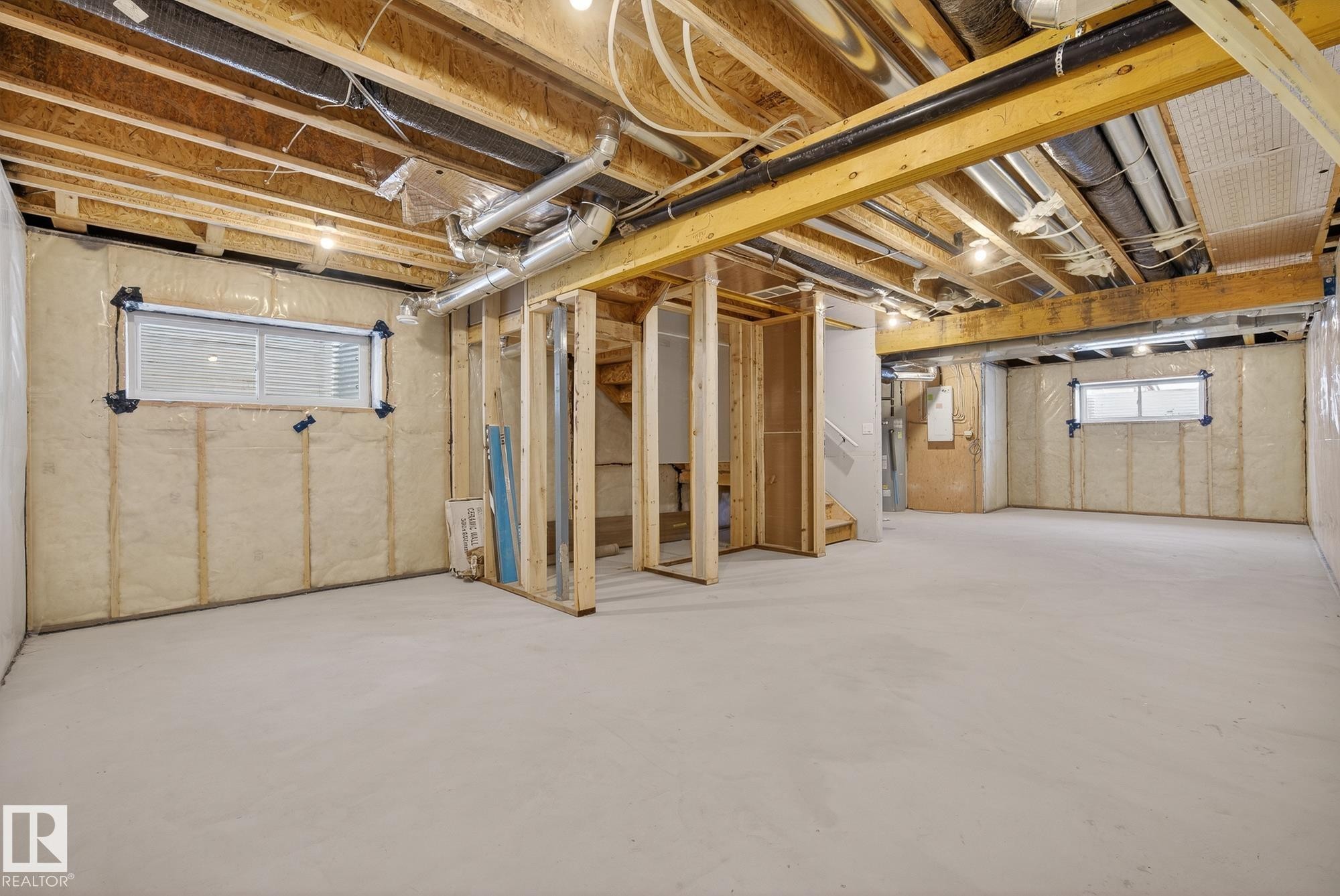 Below grade area with electric panel and stairway - 119 Brickyard Drive, Stony Plain, AB - Indoor Photo Showing Basement