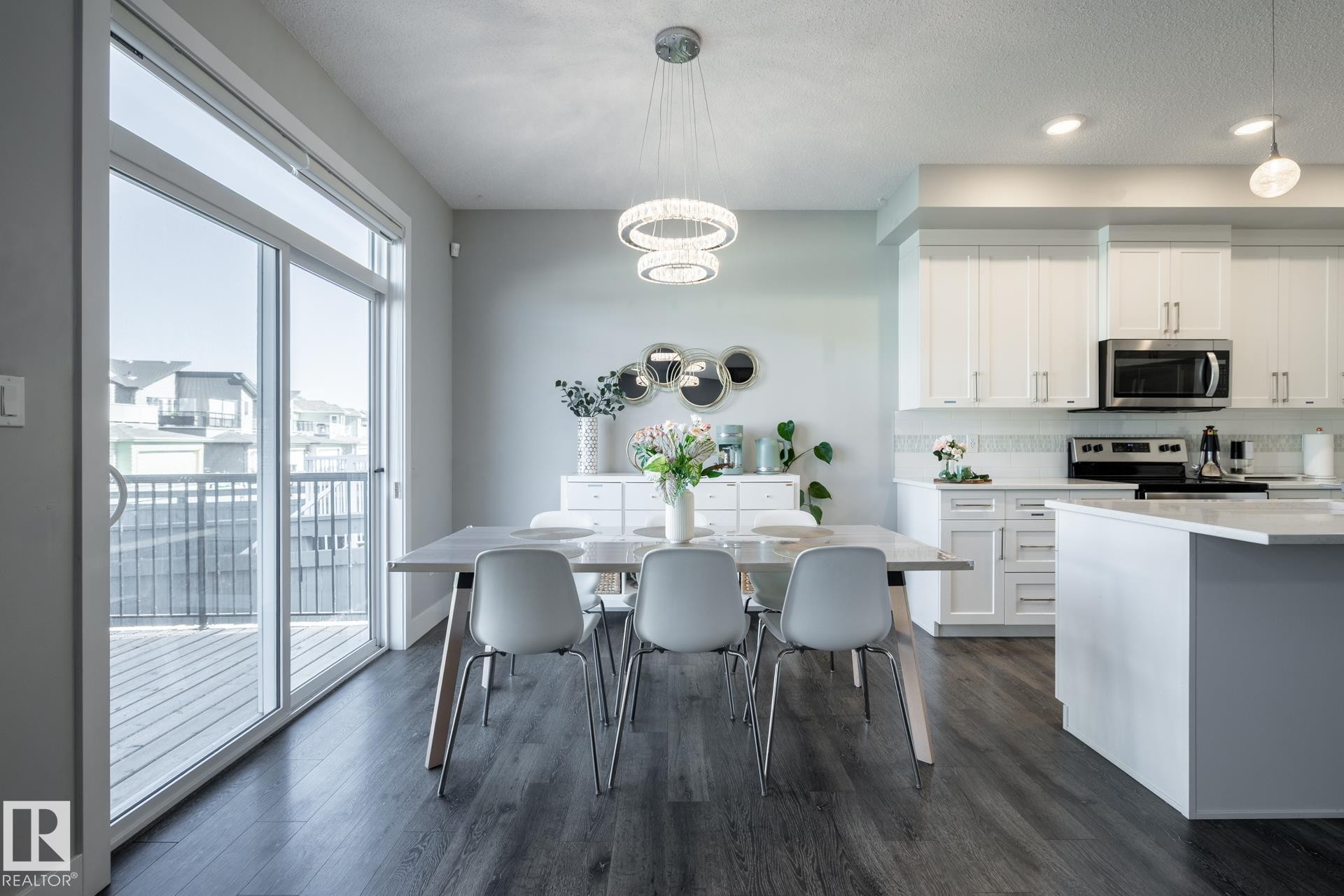 Dining space with dark wood-style flooring, a chandelier, recessed lighting, and a textured ceiling - 1440 Darby Green, Edmonton, AB - Indoor