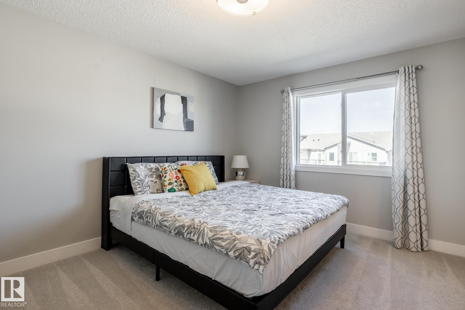 Bedroom with light colored carpet and a textured ceiling - 1440 Darby Green, Edmonton, AB - Indoor Photo Showing Bedroom