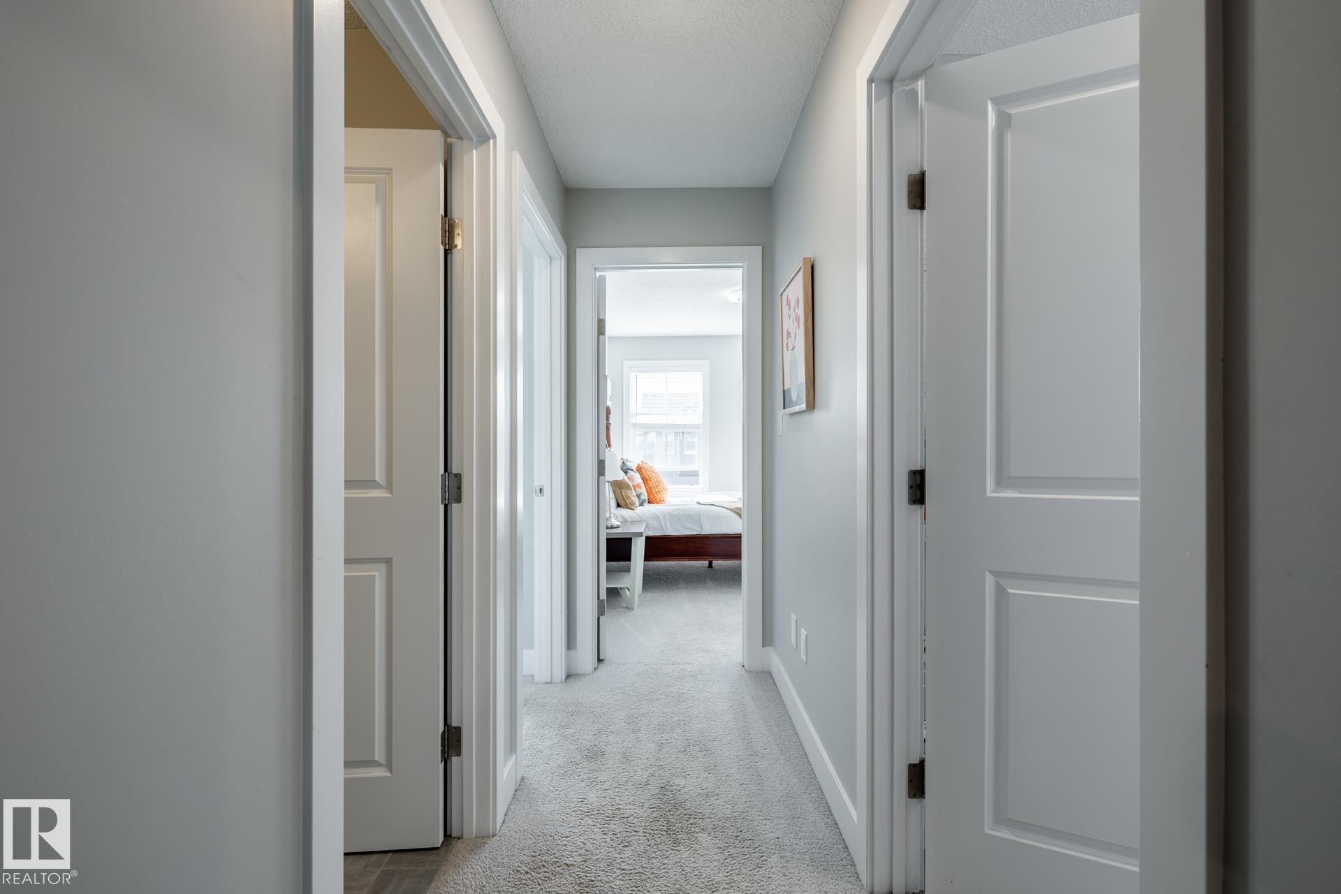 Corridor with light carpet and baseboards - 1440 Darby Green, Edmonton, AB - Indoor Photo Showing Other Room