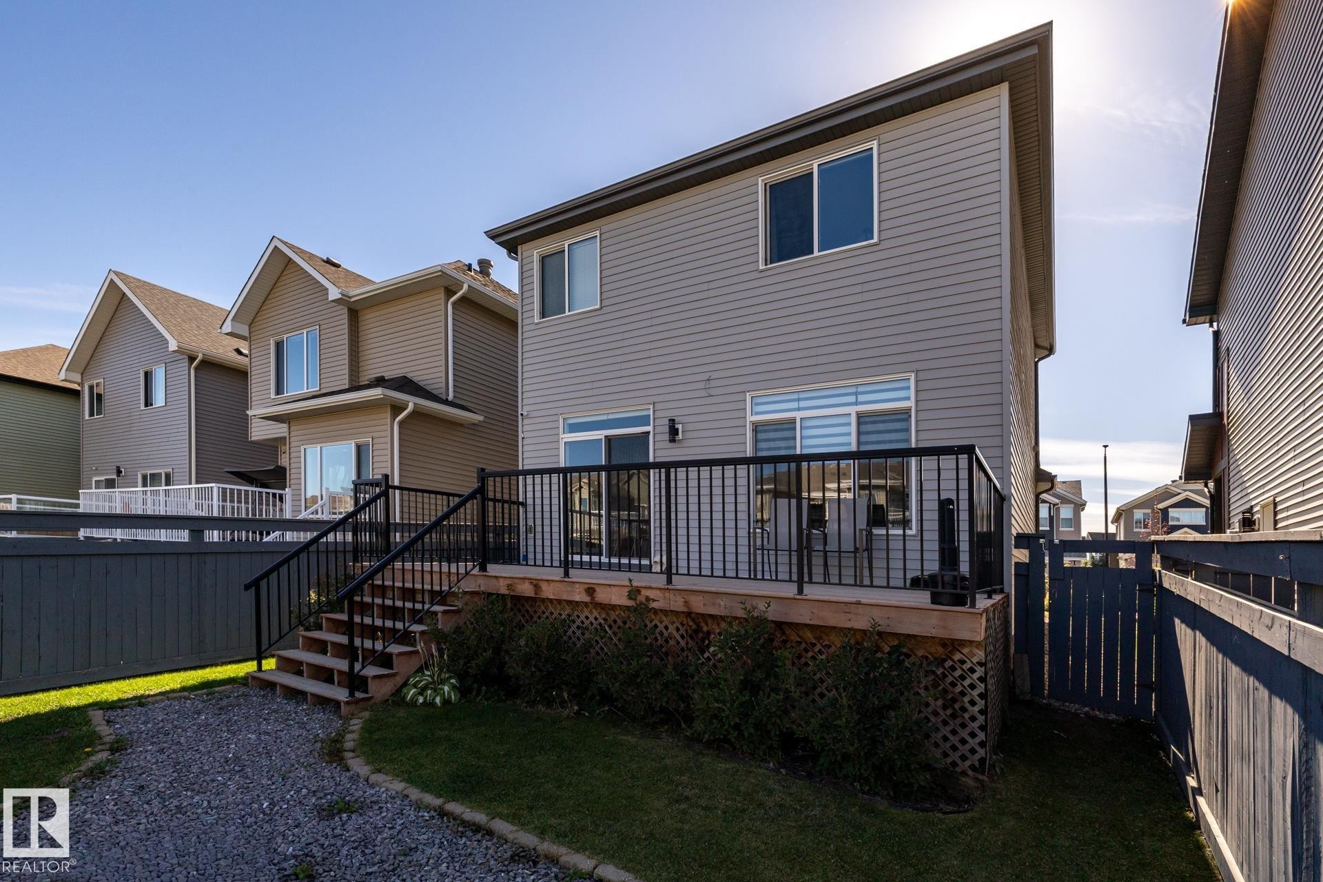 Back of house with a deck, stairway, a fenced backyard, and a residential view - 1440 Darby Green, Edmonton, AB - Outdoor With Deck Patio Veranda