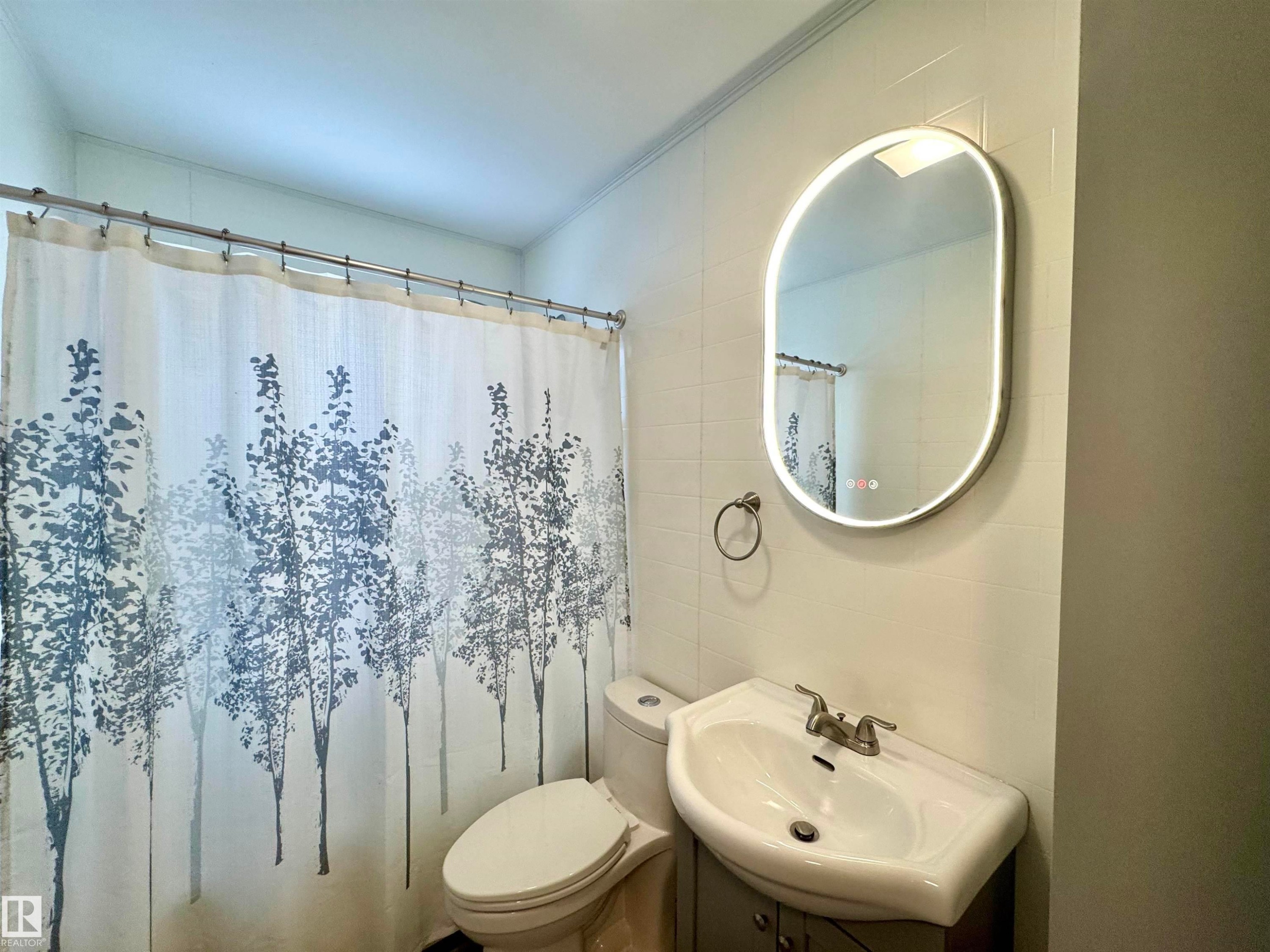 Full bathroom featuring vanity, a shower with curtain, tile walls, and ornamental molding - 5140 52 Avenue, Ryley, AB - Indoor Photo Showing Bathroom