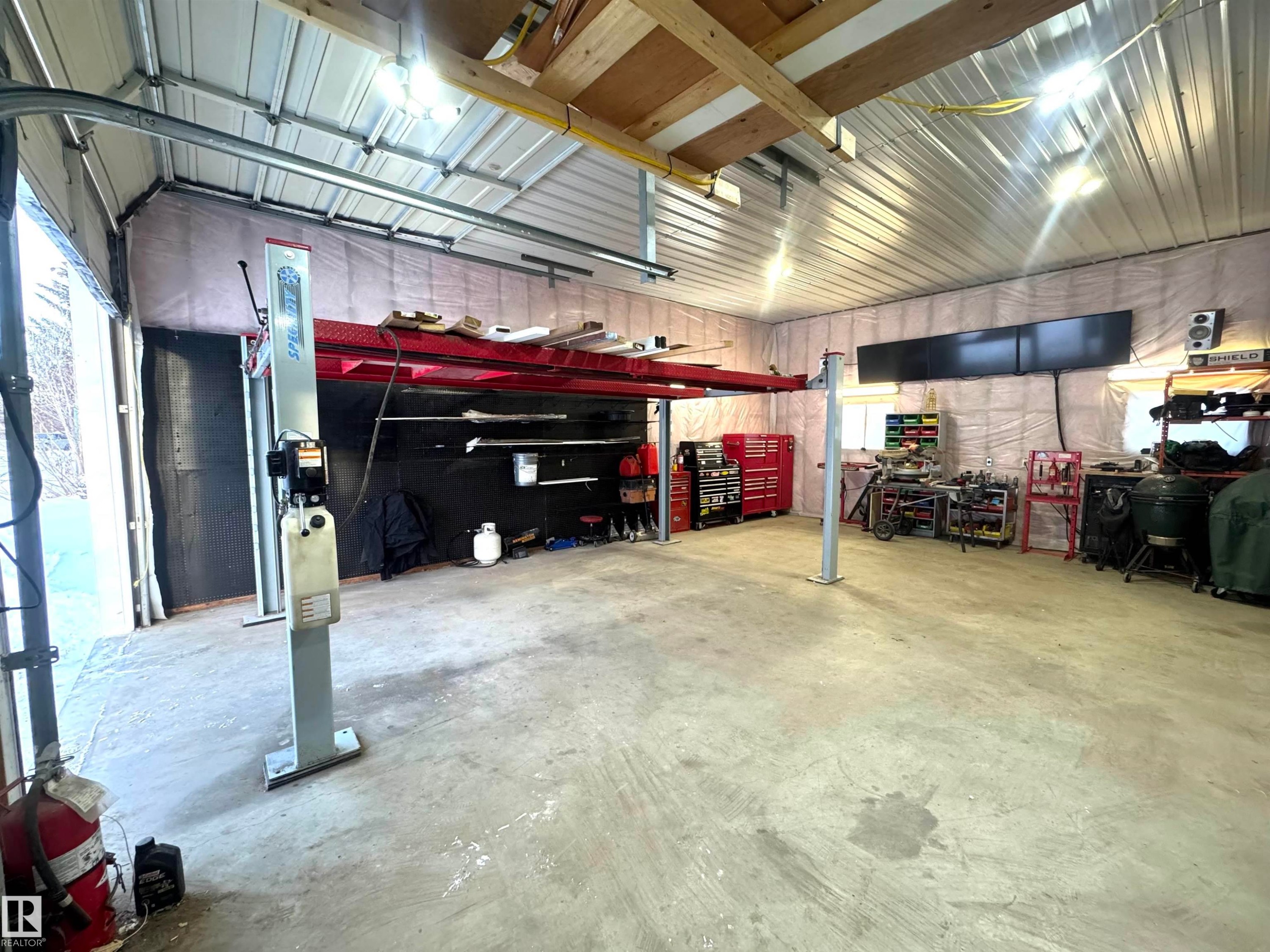 Garage with metal wall - 5140 52 Avenue, Ryley, AB - Indoor Photo Showing Garage