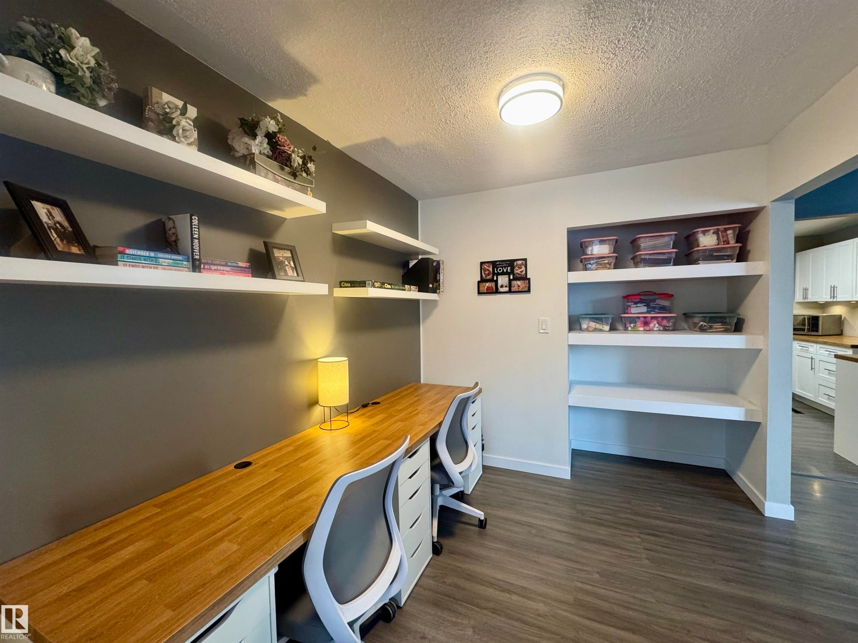 Office space featuring a textured ceiling, built in study area, and dark wood-type flooring - 5140 52 Avenue, Ryley, AB - Indoor Photo Showing Office