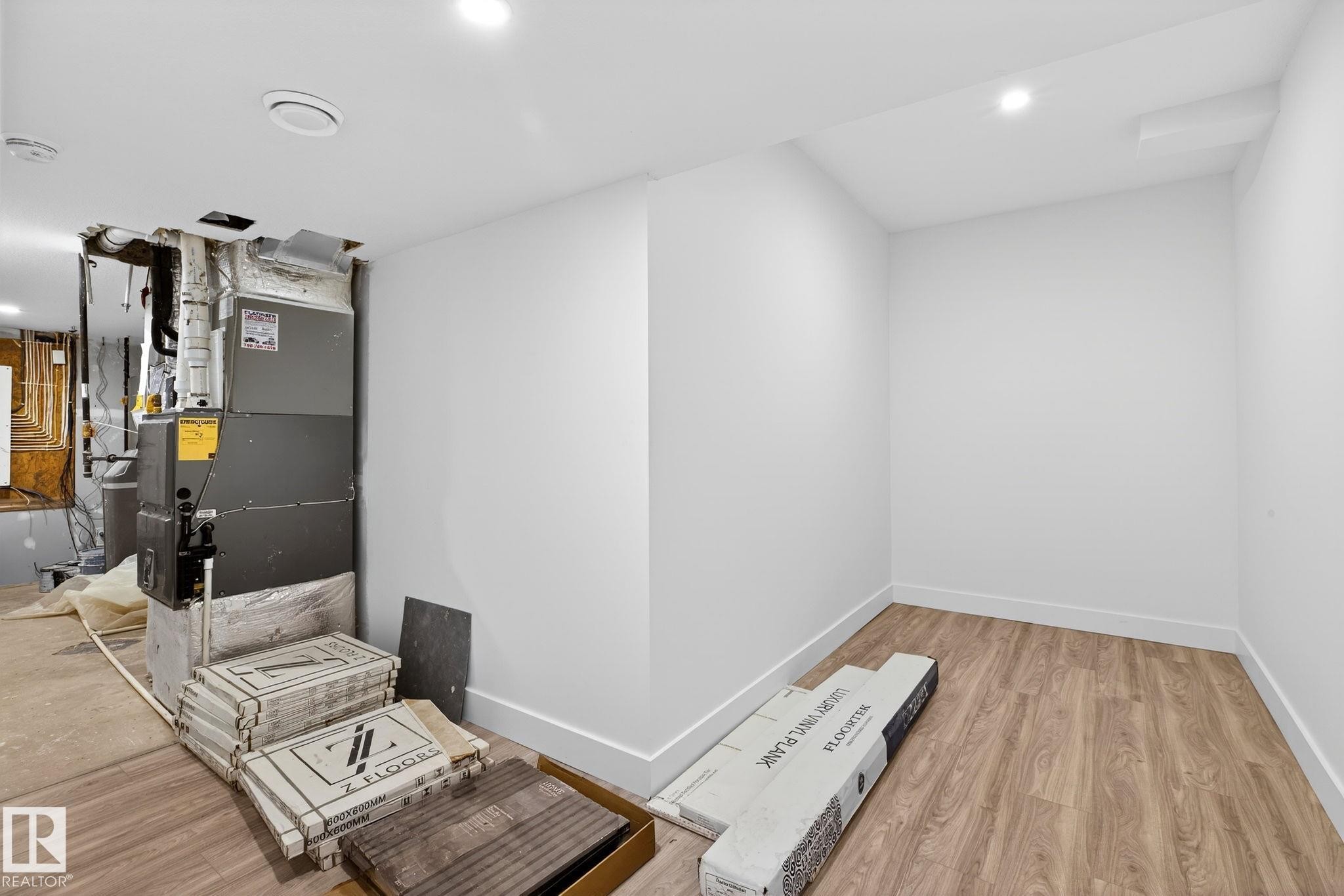 Utility room featuring heating unit - 1926 Ainslie Link, Edmonton, AB - Indoor Photo Showing Other Room