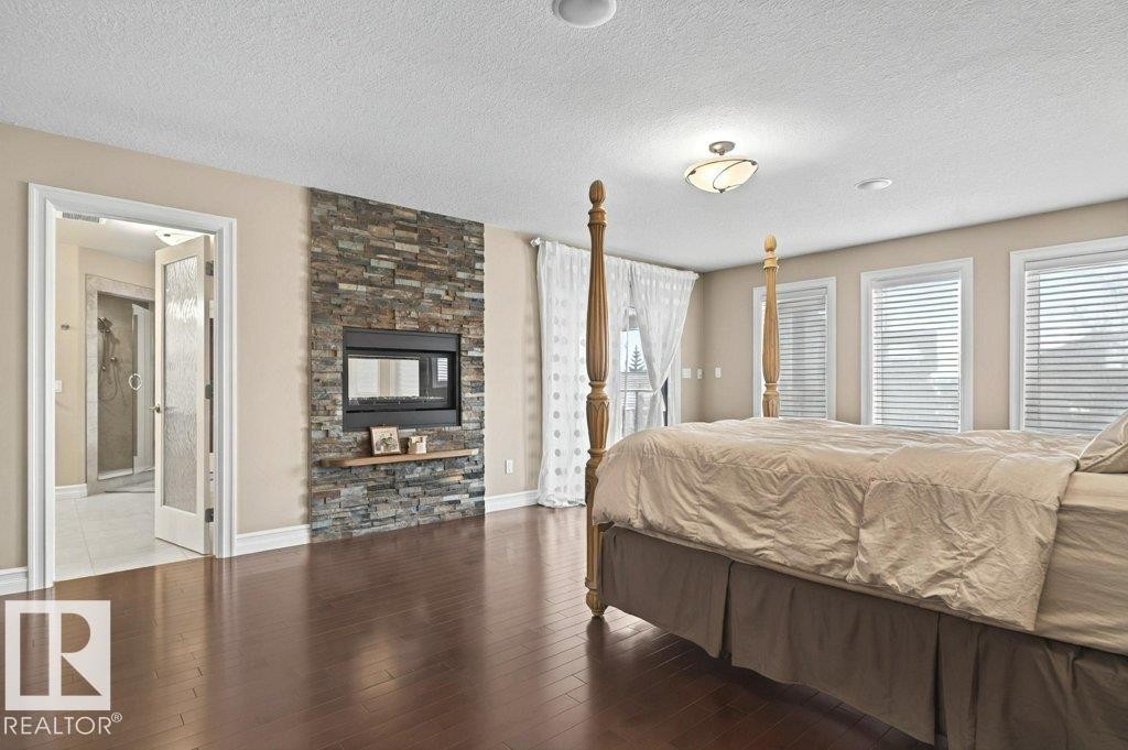 4835 Mactaggart Crest Crest, Edmonton, AB - Indoor Photo Showing Bedroom With Fireplace