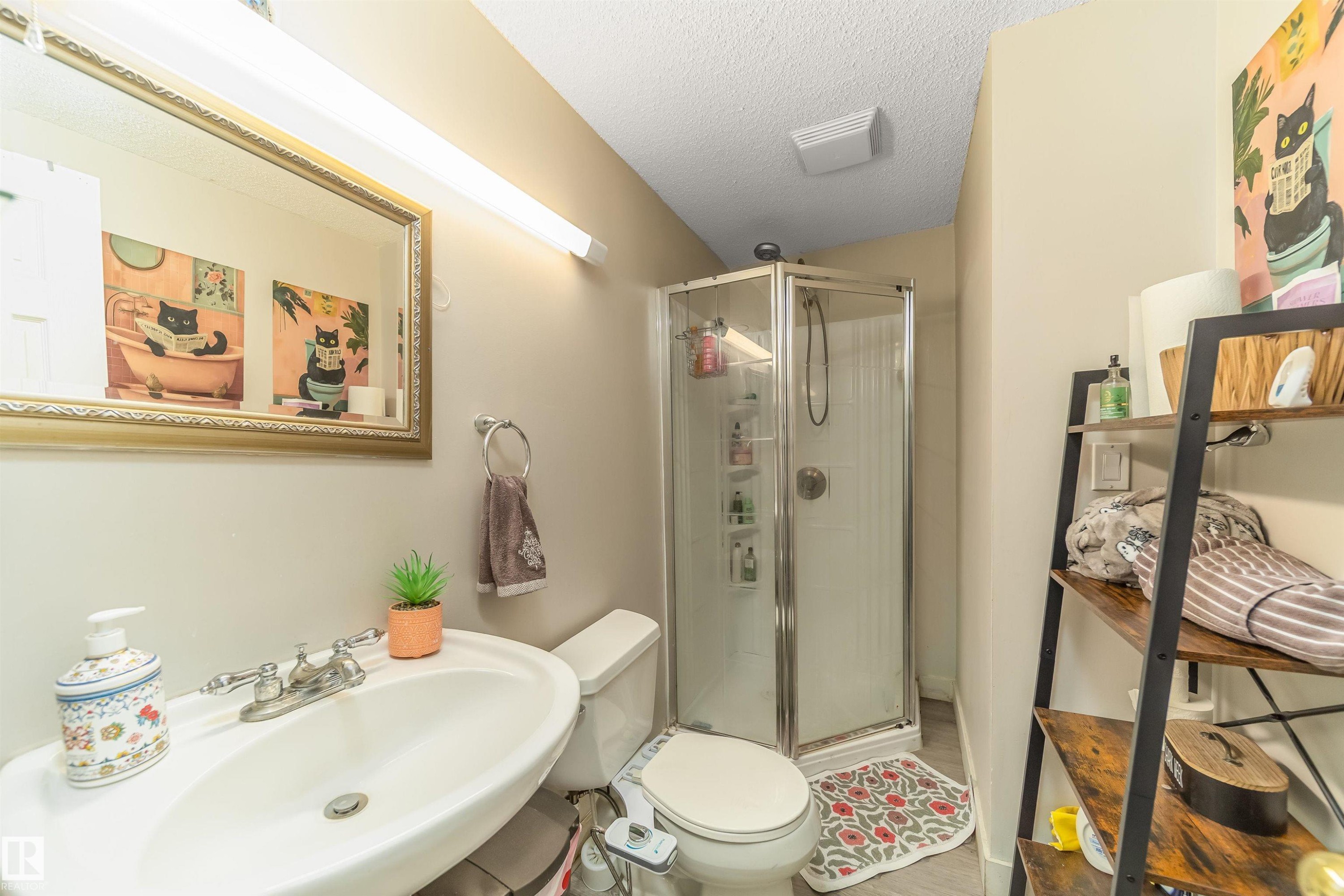 Bathroom with a textured ceiling and a stall shower - 8518 6 Av, Edmonton, AB - Indoor Photo Showing Bathroom