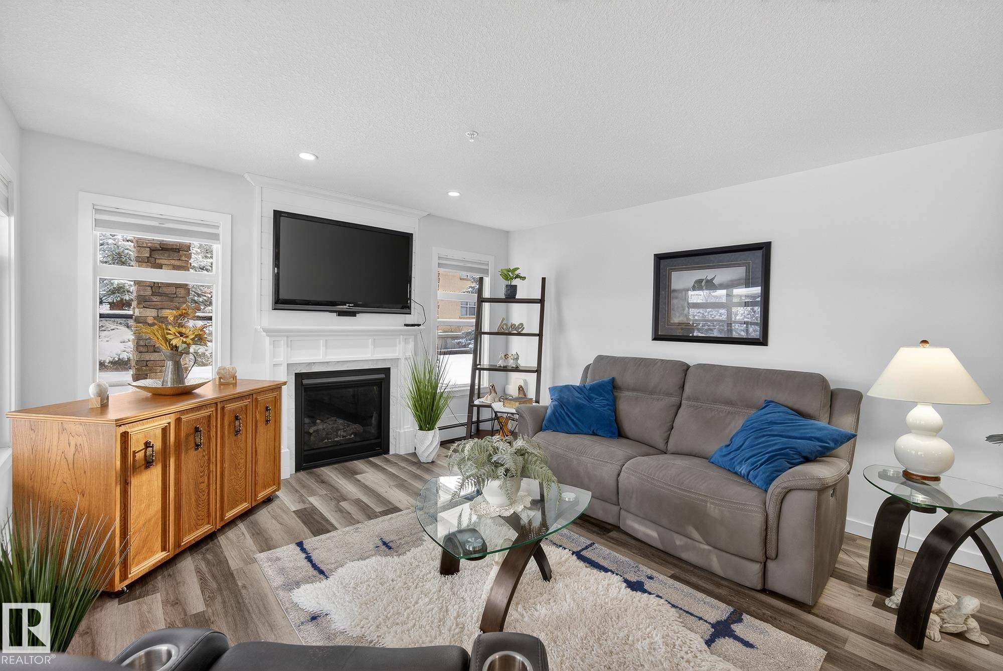 134 11505 Ellerslie Road, Edmonton, AB - Indoor Photo Showing Living Room With Fireplace