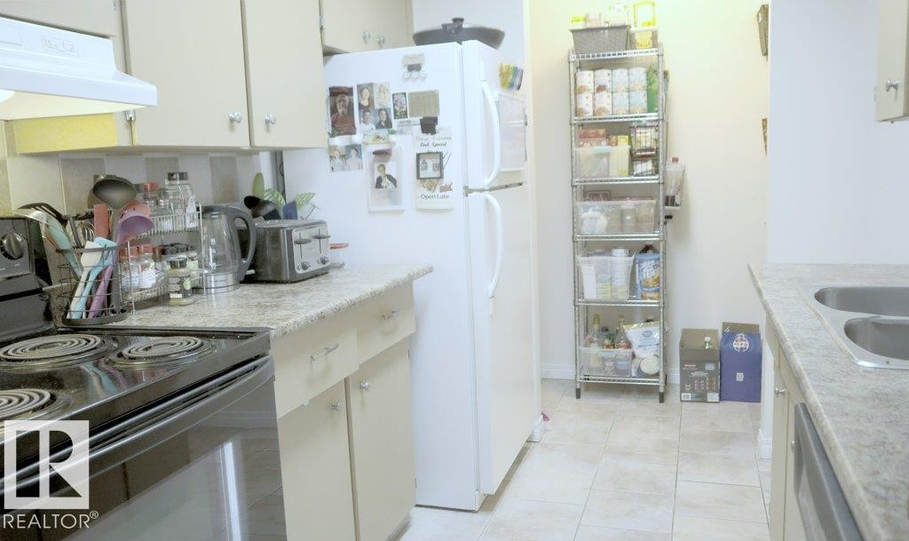 111 5125 Riverbend Road, Edmonton, AB - Indoor Photo Showing Kitchen With Double Sink