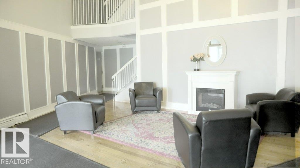 111 5125 Riverbend Road, Edmonton, AB - Indoor Photo Showing Living Room With Fireplace