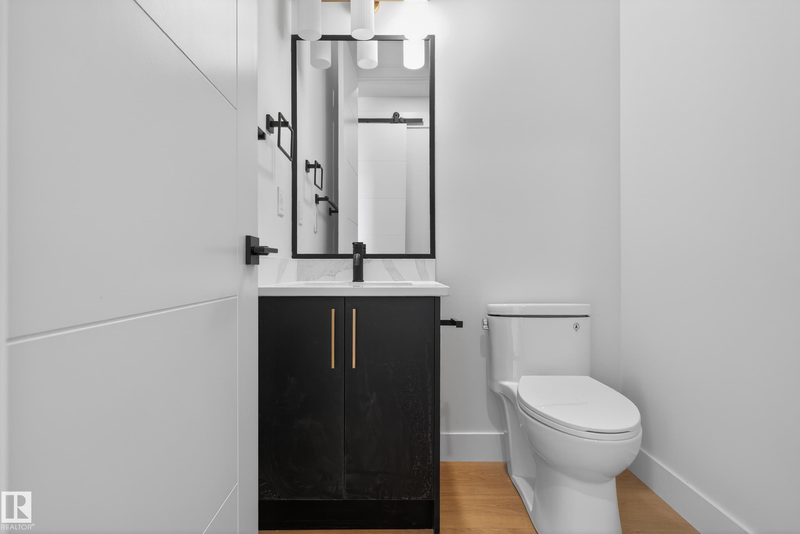 Half bath featuring vanity and light wood-style floors - 19 Rosa Crescent, St. Albert, AB - Indoor Photo Showing Bathroom