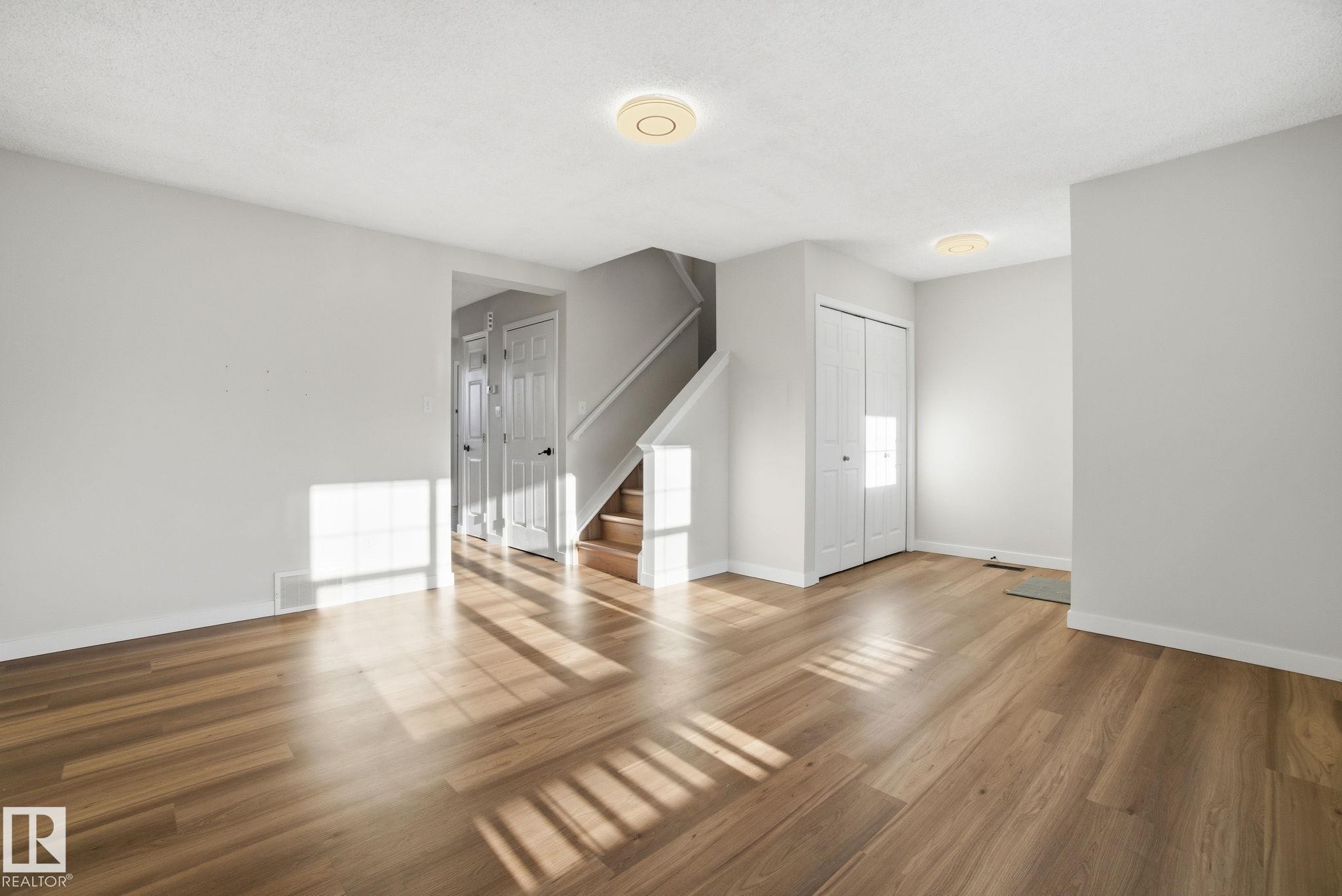 Living room with new light wood laminate flooring - 3014 31 Avenue, Edmonton, AB - Indoor