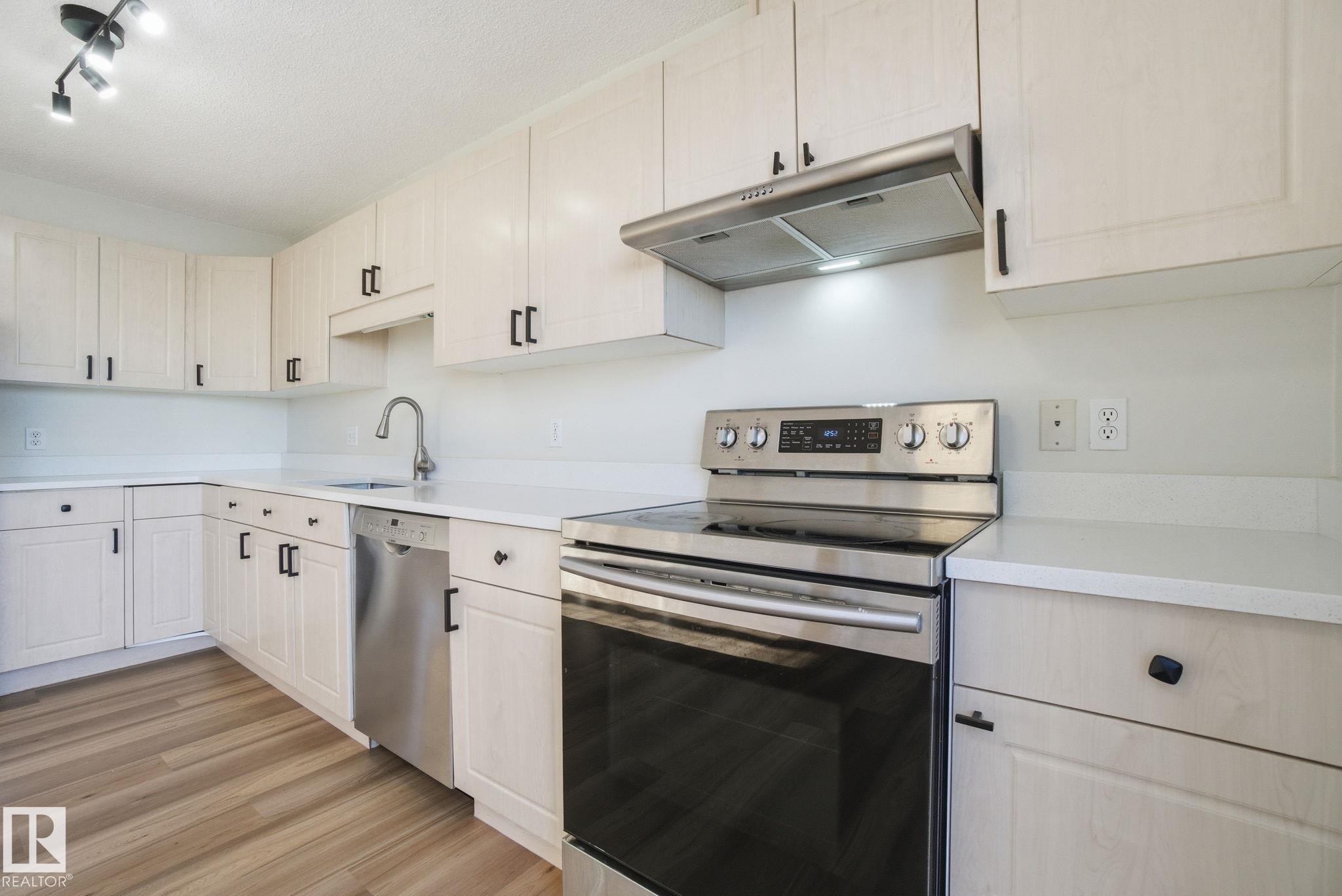 Kitchen with stainless steel appliances and new countertops - 3014 31 Avenue, Edmonton, AB - Indoor Photo Showing Kitchen