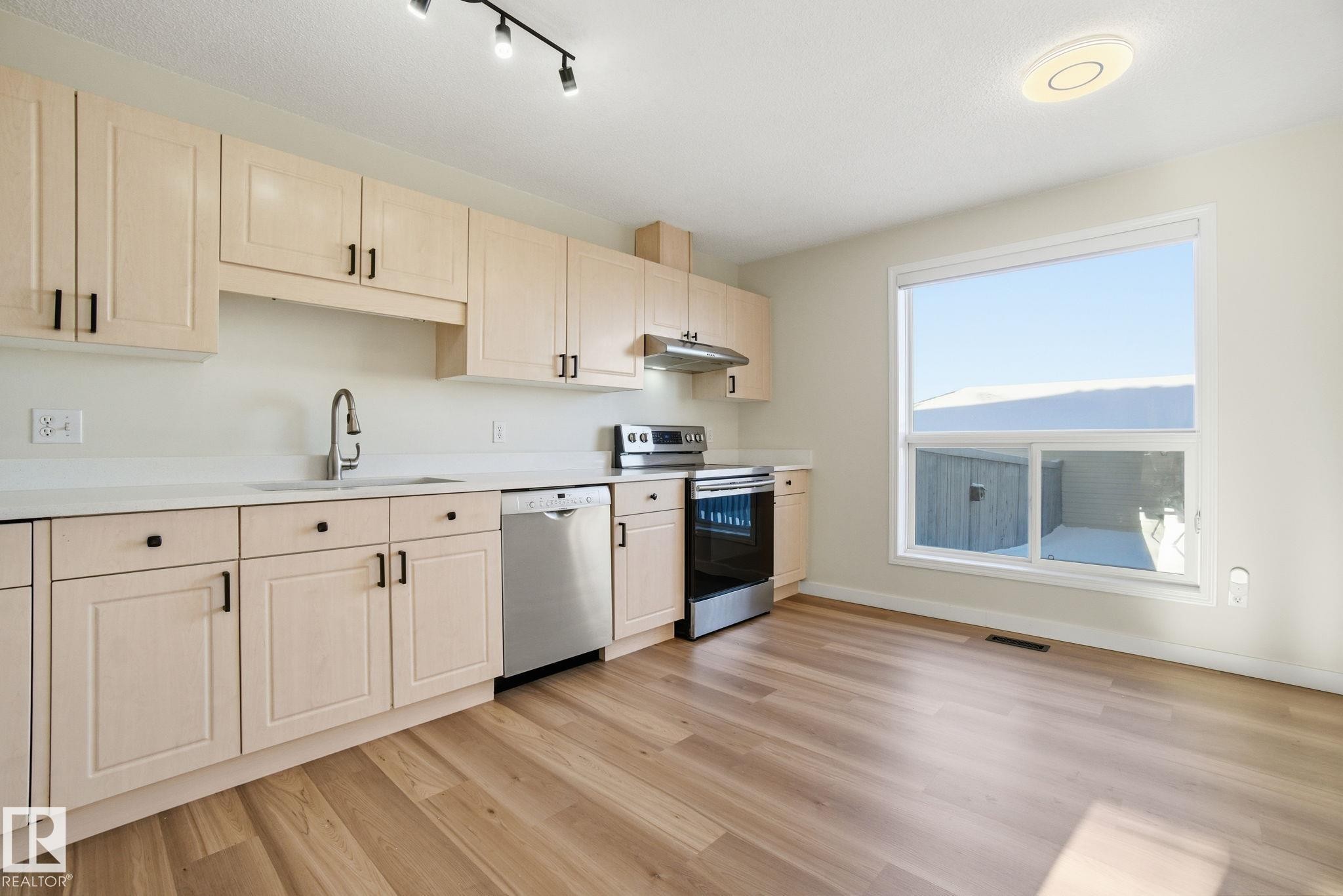 Kitchen with stainless steel appliances and new countertops - 3014 31 Avenue, Edmonton, AB - Indoor Photo Showing Kitchen