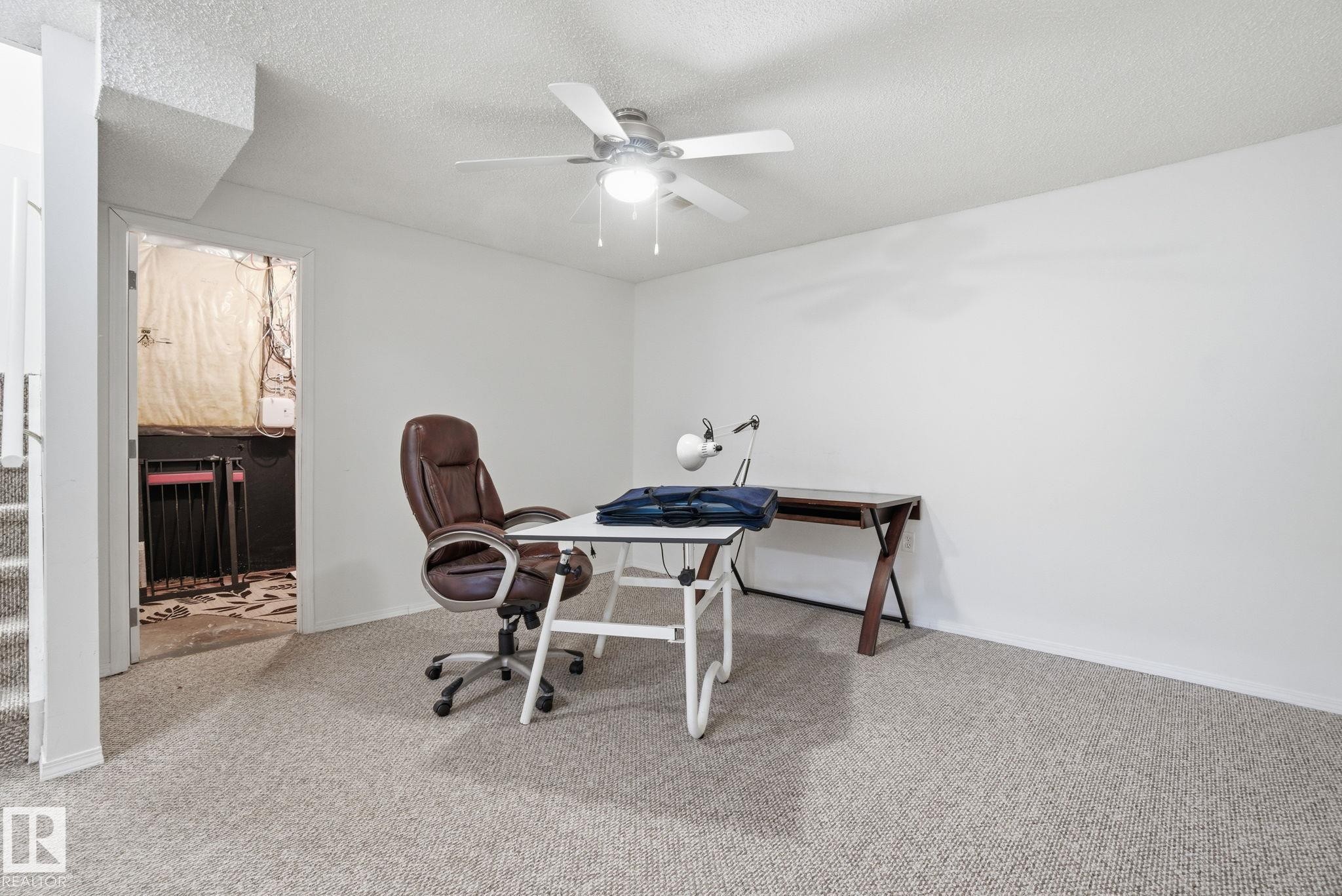 Basement with a glass covered fireplace and light carpet - 3014 31 Avenue, Edmonton, AB - Indoor Photo Showing Office