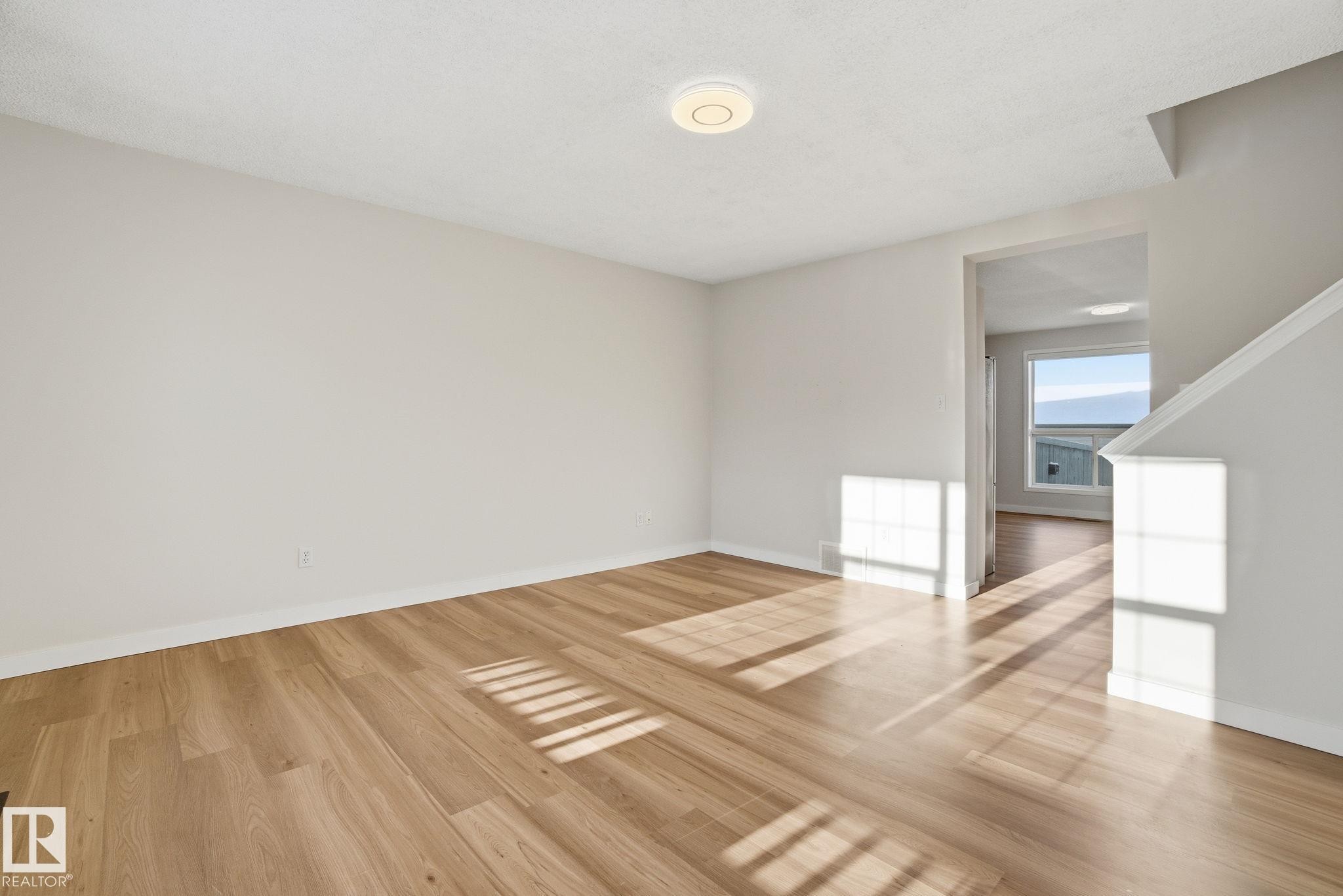 Living room with new light wood laminate flooring - 3014 31 Avenue, Edmonton, AB - Indoor Photo Showing Other Room