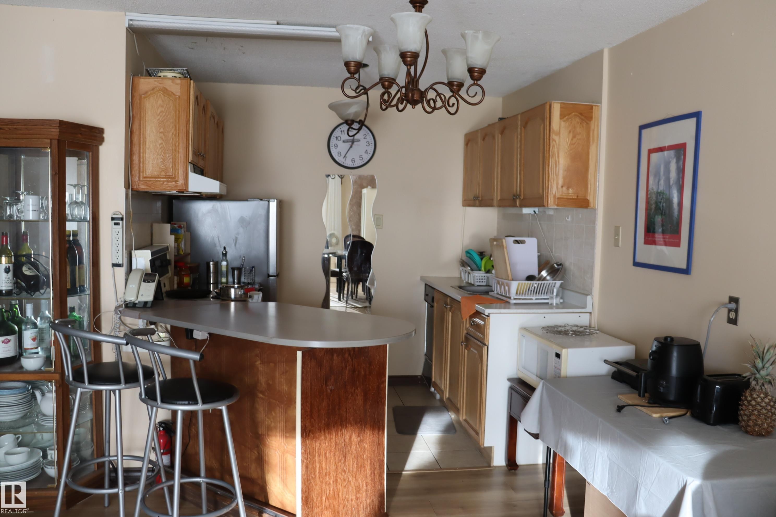 With small eating bar. - #203 9028 Jasper Ave Nw, Edmonton, AB - Indoor