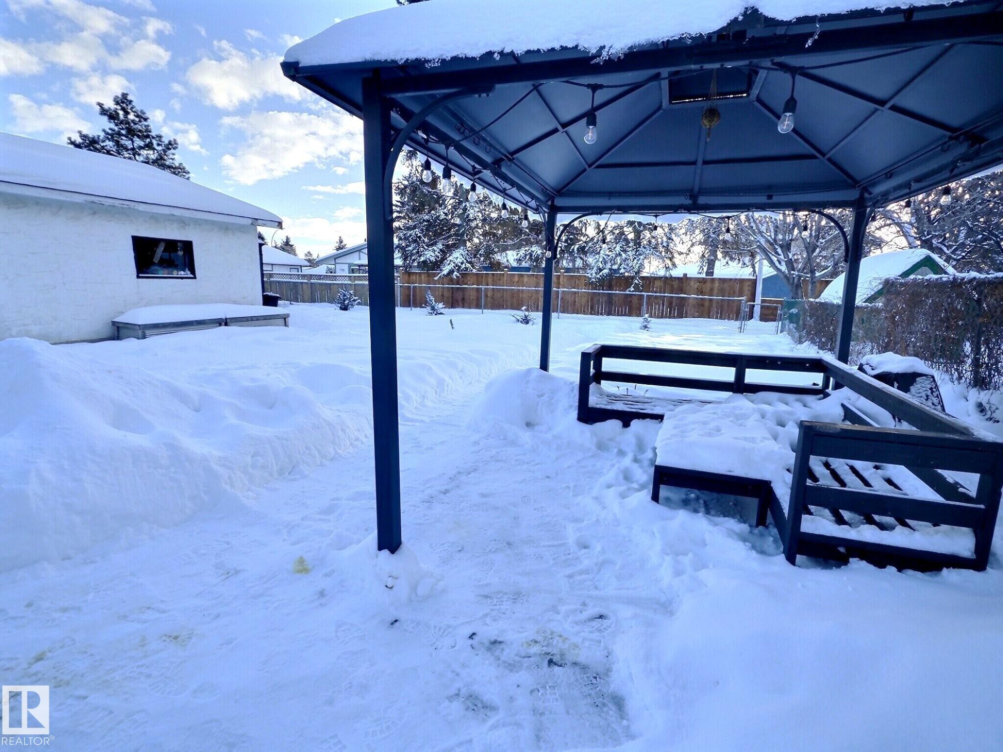 Snowy yard with a fenced backyard and a gazebo - 17119 82 Avenue, Edmonton, AB - Outdoor