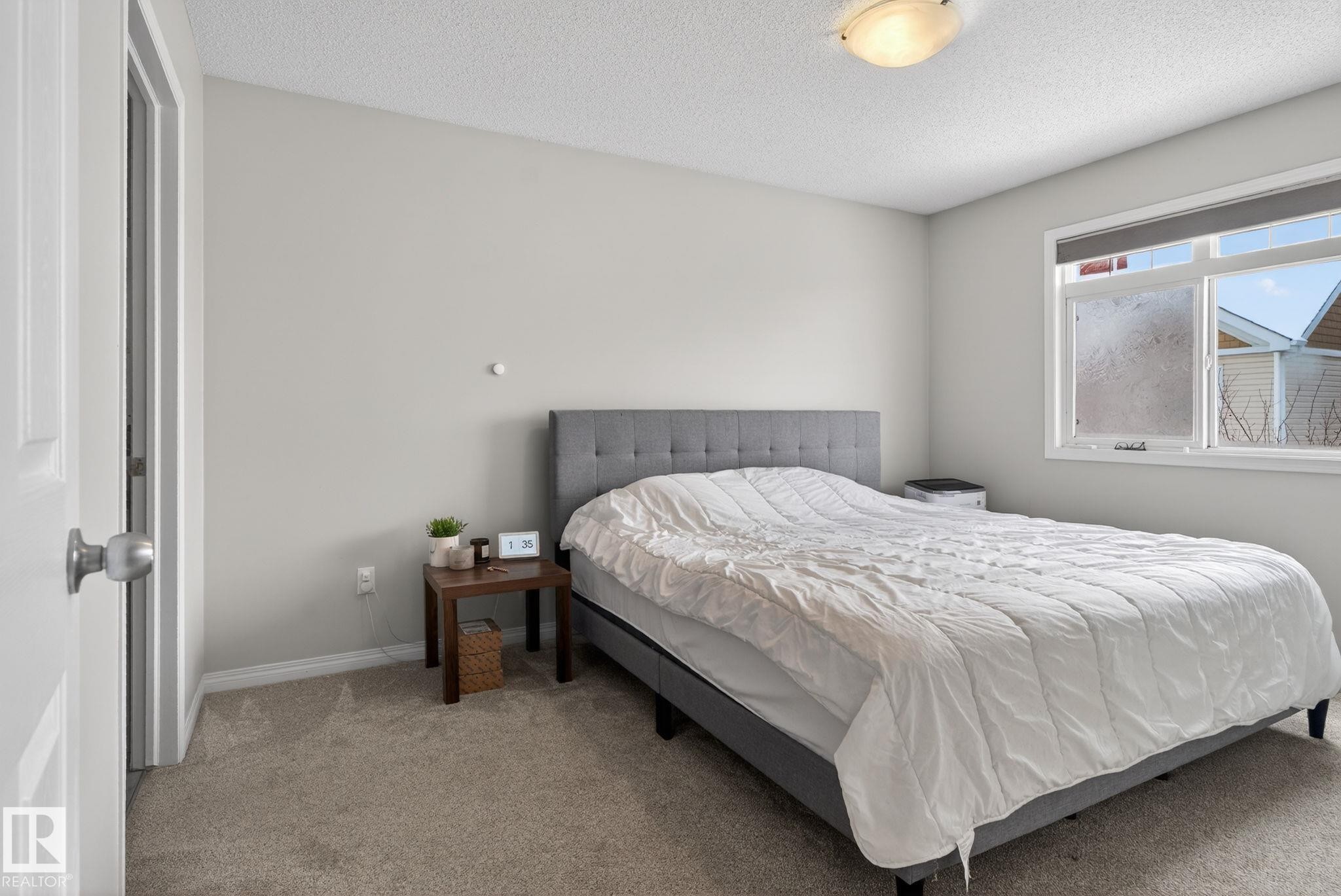 Carpeted bedroom featuring a textured ceiling and baseboards - 60 1804 70 Street, Edmonton, AB - Indoor Photo Showing Bedroom