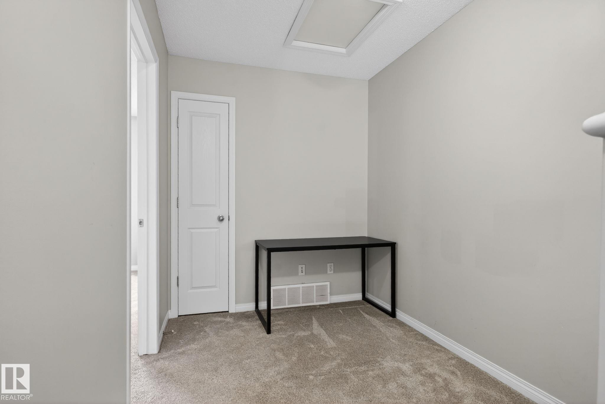 Empty room with light colored carpet and baseboards - 60 1804 70 Street, Edmonton, AB - Indoor Photo Showing Other Room