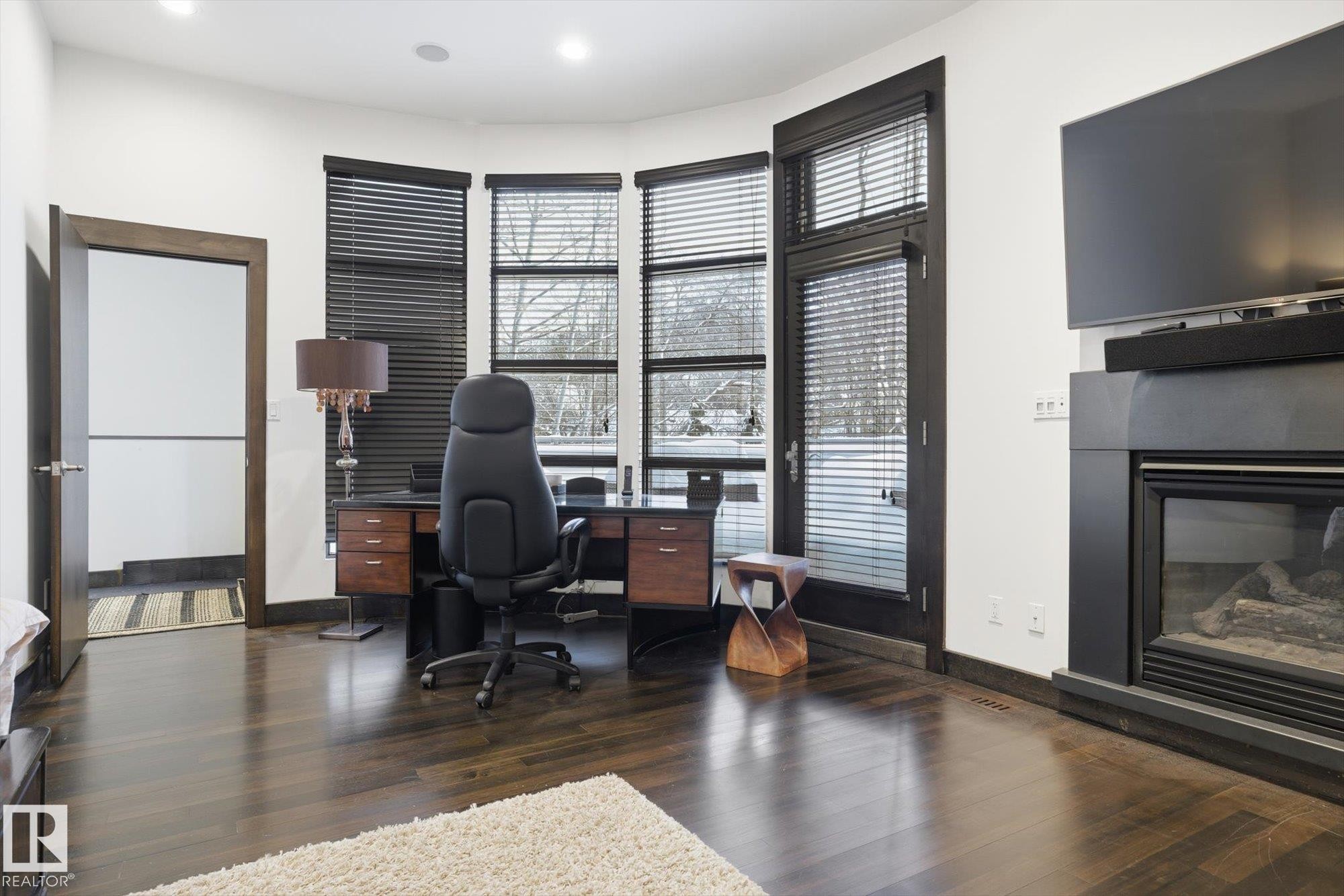 Office featuring a glass covered fireplace, dark wood-style floors, and recessed lighting - 9012 98 Street, Edmonton, AB - Indoor With Fireplace