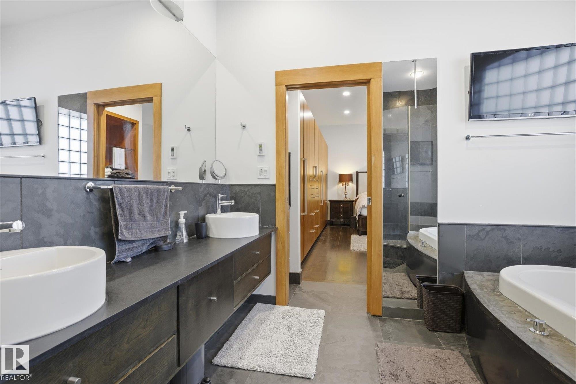 Bathroom featuring double vanity, a tub, ensuite bath, and tiled shower - 9012 98 Street, Edmonton, AB - Indoor Photo Showing Bathroom