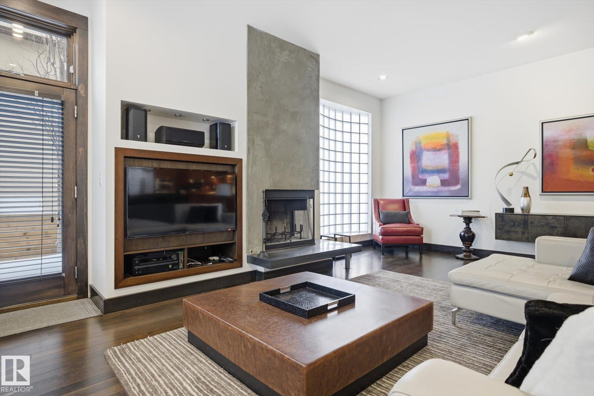 Living room with a large fireplace, dark wood-type flooring, and recessed lighting - 9012 98 Street, Edmonton, AB - Indoor Photo Showing Living Room With Fireplace