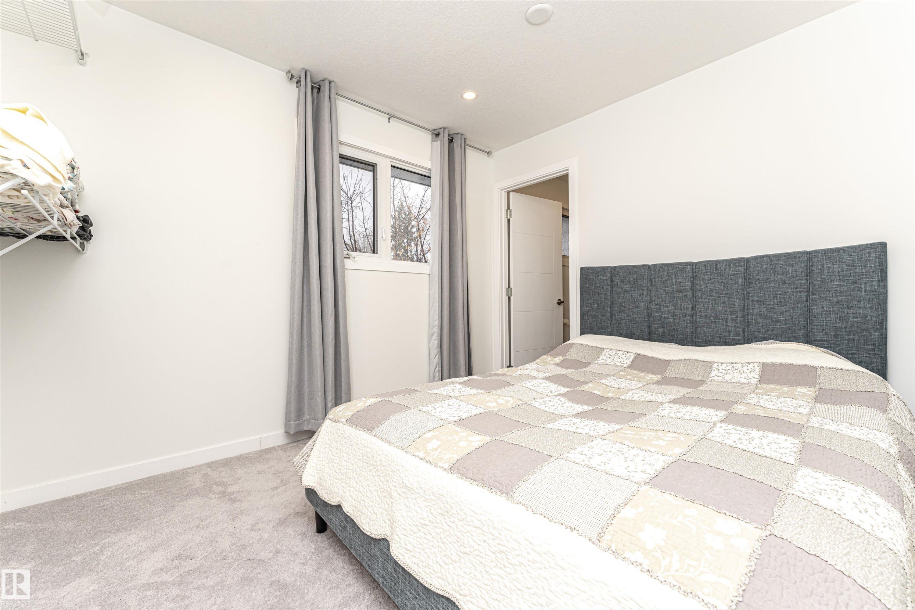 Bedroom with baseboards and light colored carpet - 17716 84 Avenue, Edmonton, AB - Indoor Photo Showing Bedroom