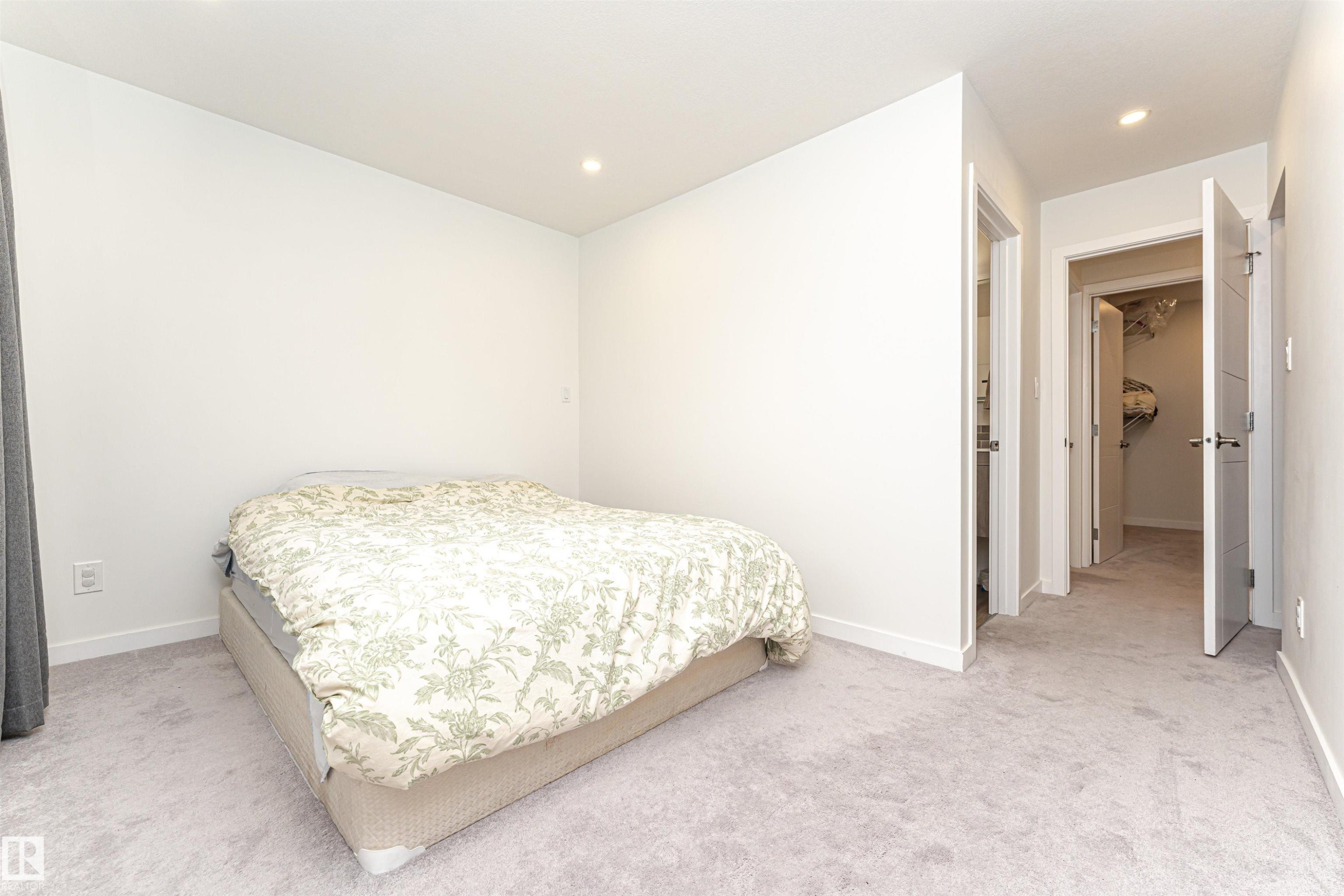 Bedroom featuring light carpet, recessed lighting, and a walk in closet - 17716 84 Avenue, Edmonton, AB - Indoor Photo Showing Bedroom