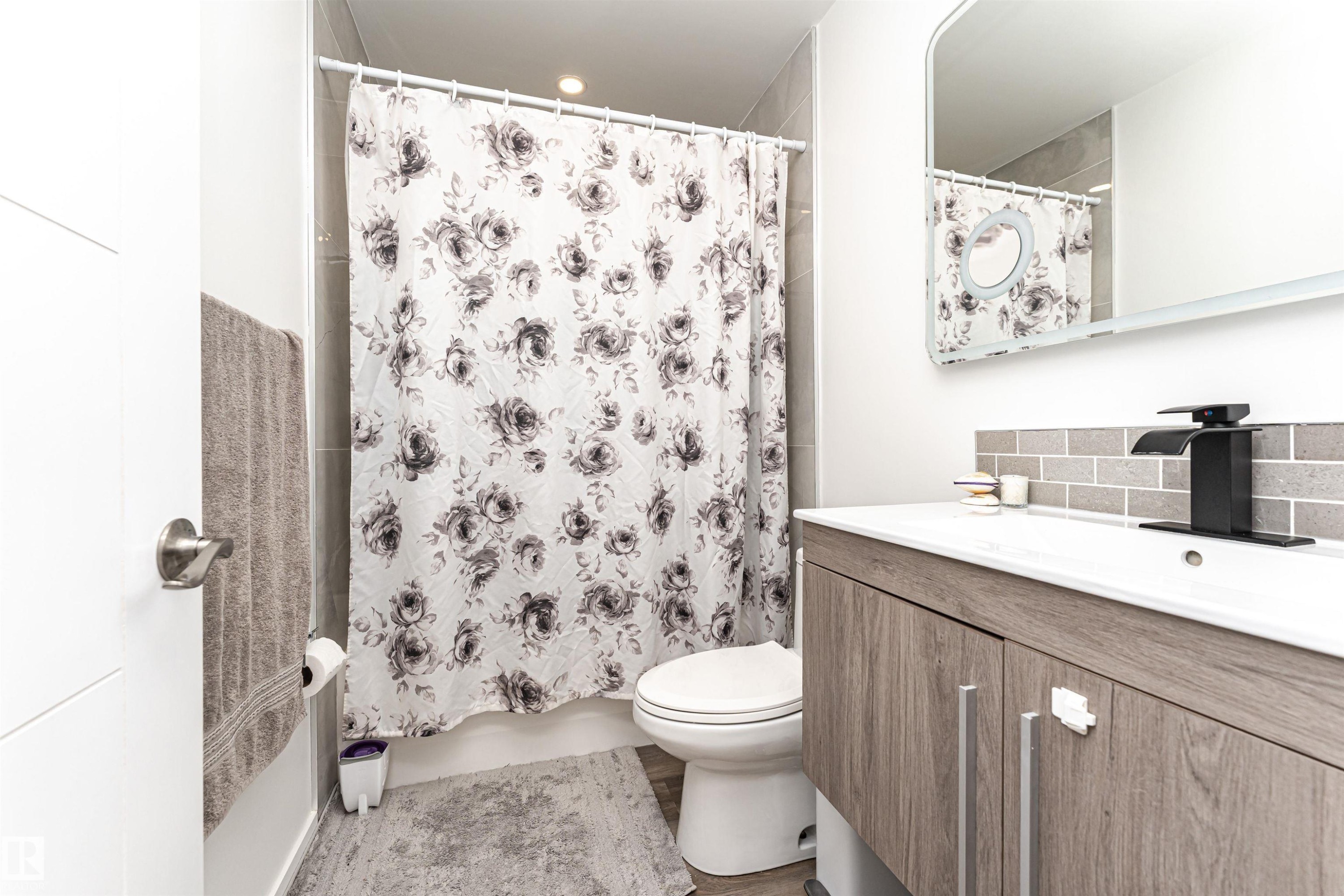 Bathroom with vanity and shower / bathtub combination with curtain - 17716 84 Avenue, Edmonton, AB - Indoor Photo Showing Bathroom