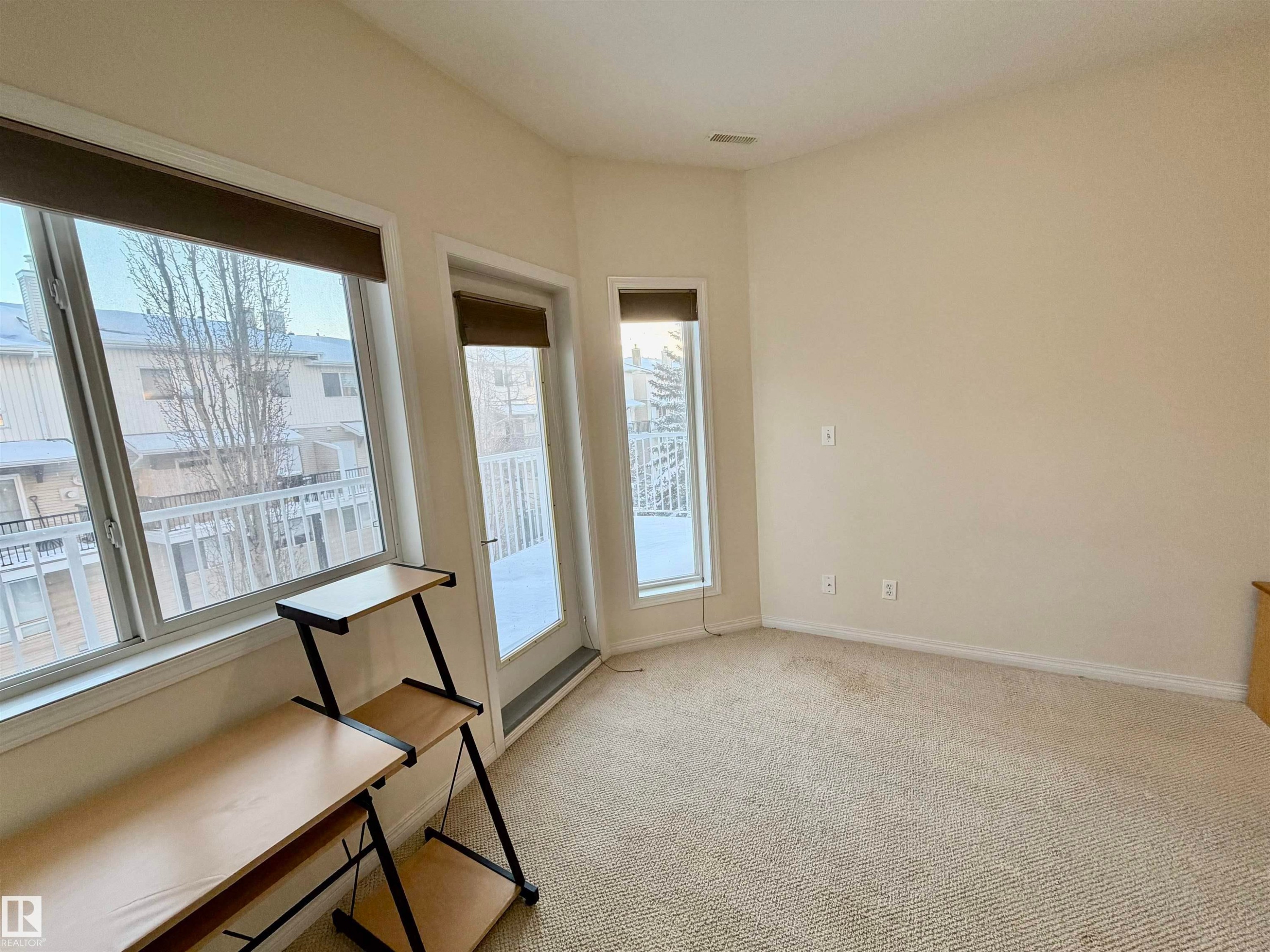 Unfurnished room with light colored carpet and baseboards - 321 4304 139 Avenue, Edmonton, AB - Indoor Photo Showing Other Room