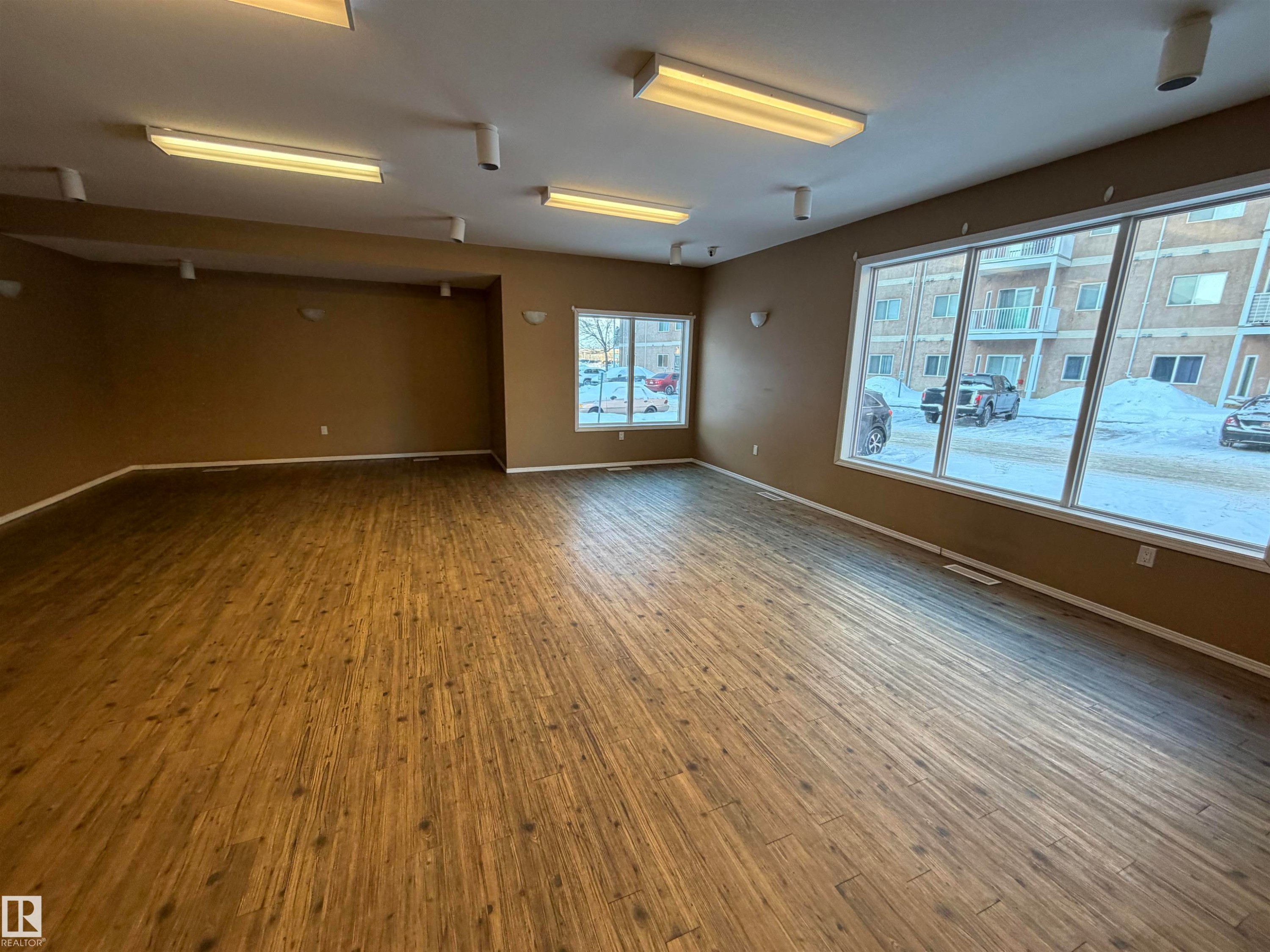 Empty room with baseboards and wood finished floors - 321 4304 139 Avenue, Edmonton, AB - Indoor Photo Showing Other Room