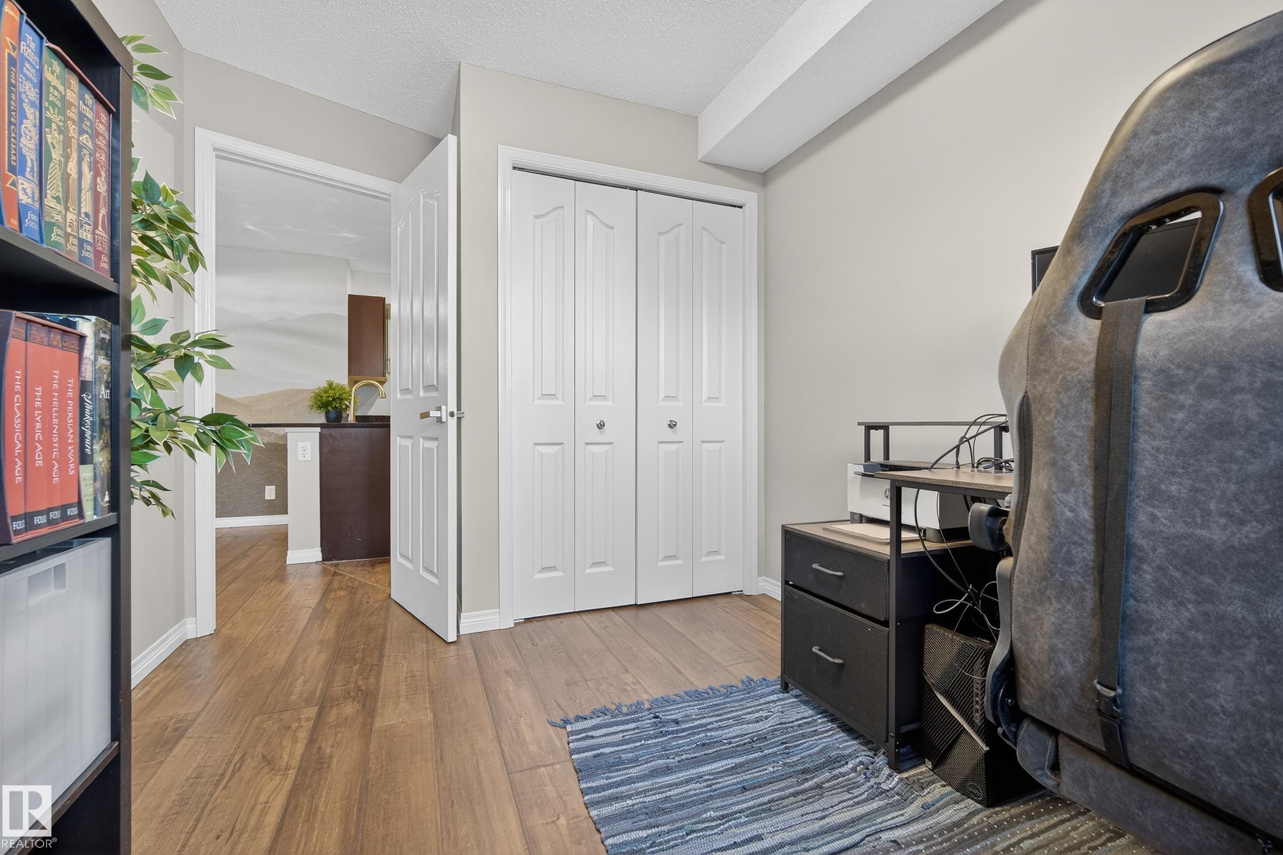Office with wood-type flooring and a textured ceiling - 108 534 Watt Boulevard, Edmonton, AB - Indoor