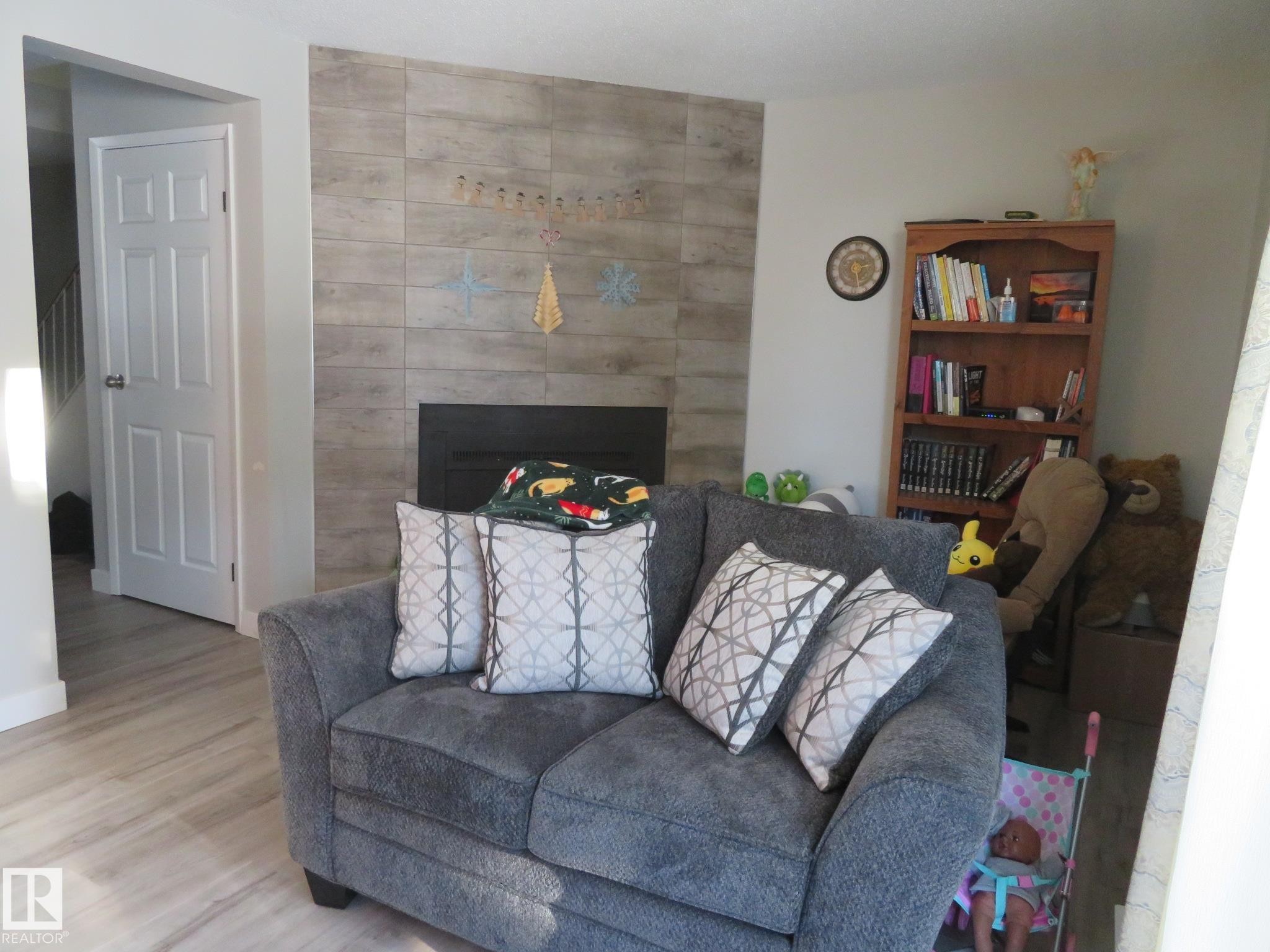 Living room featuring a fireplace and wood finished floors - 3103 109 Street, Edmonton, AB - Indoor Photo Showing Living Room With Fireplace
