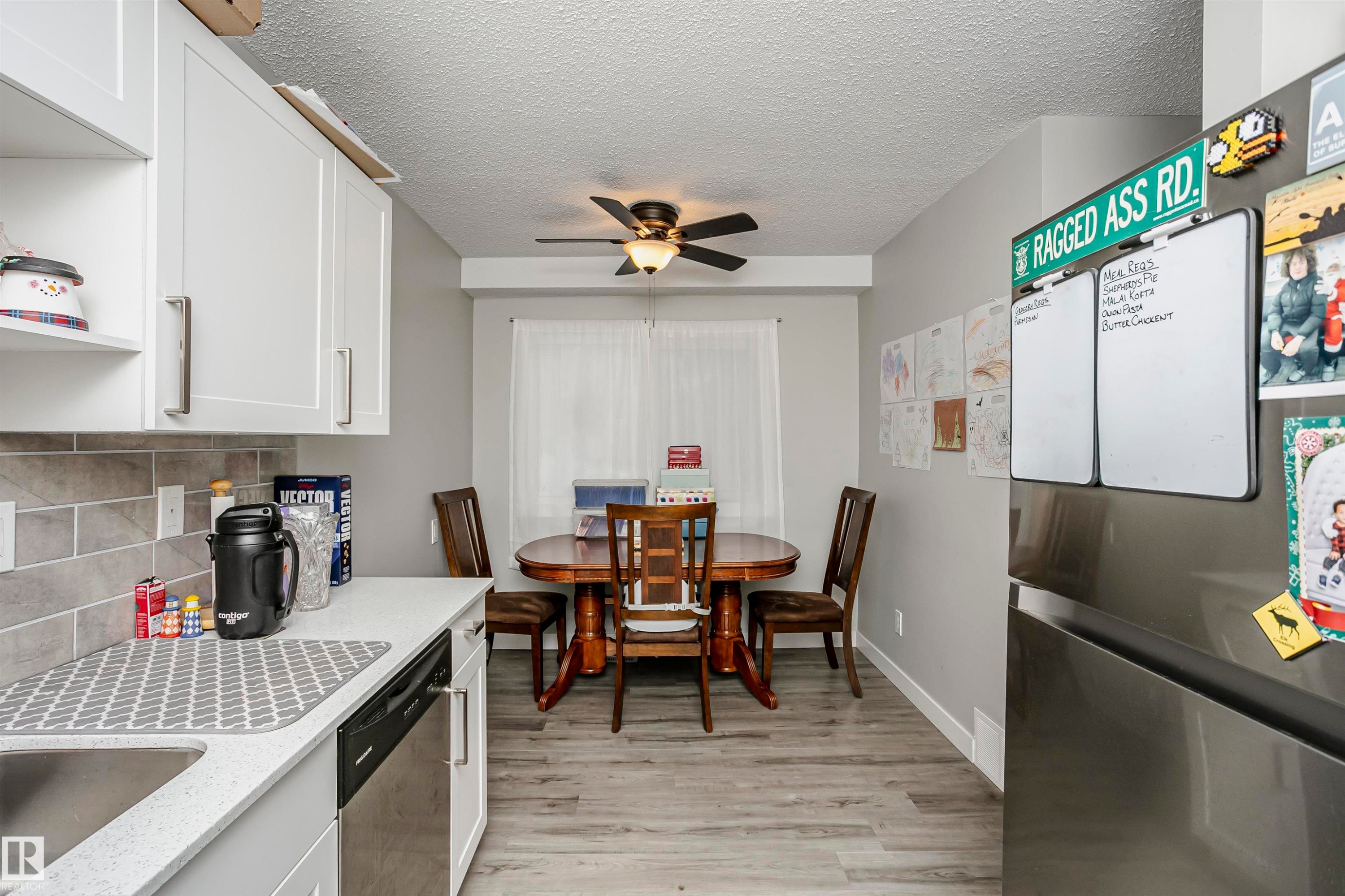 Kitchen with stainless steel appliances, decorative backsplash, ceiling fan, open shelves, and light wood-style floors - 3103 109 Street, Edmonton, AB - Indoor