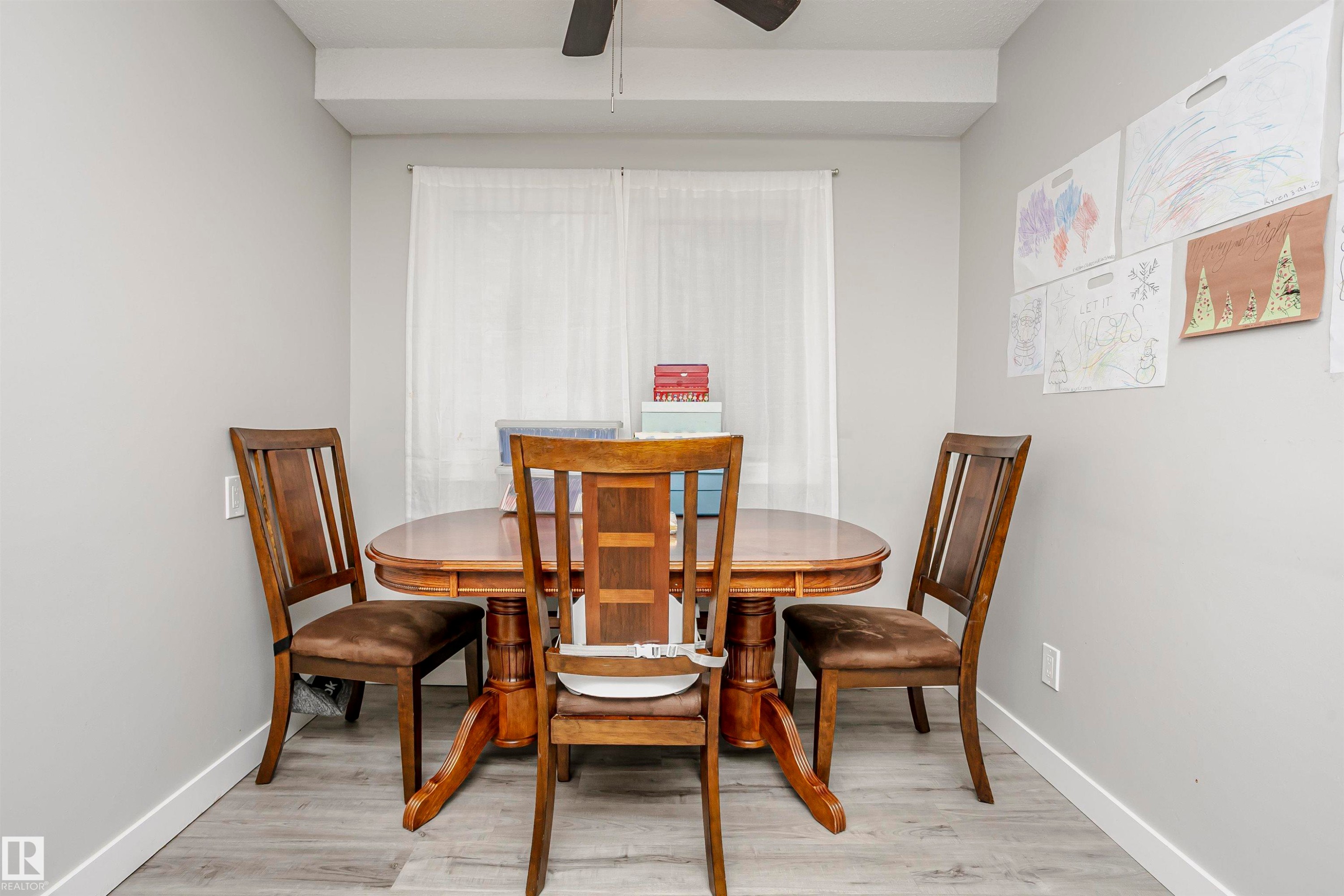 Dining space featuring light wood-style flooring and a ceiling fan - 3103 109 Street, Edmonton, AB - Indoor Photo Showing Dining Room
