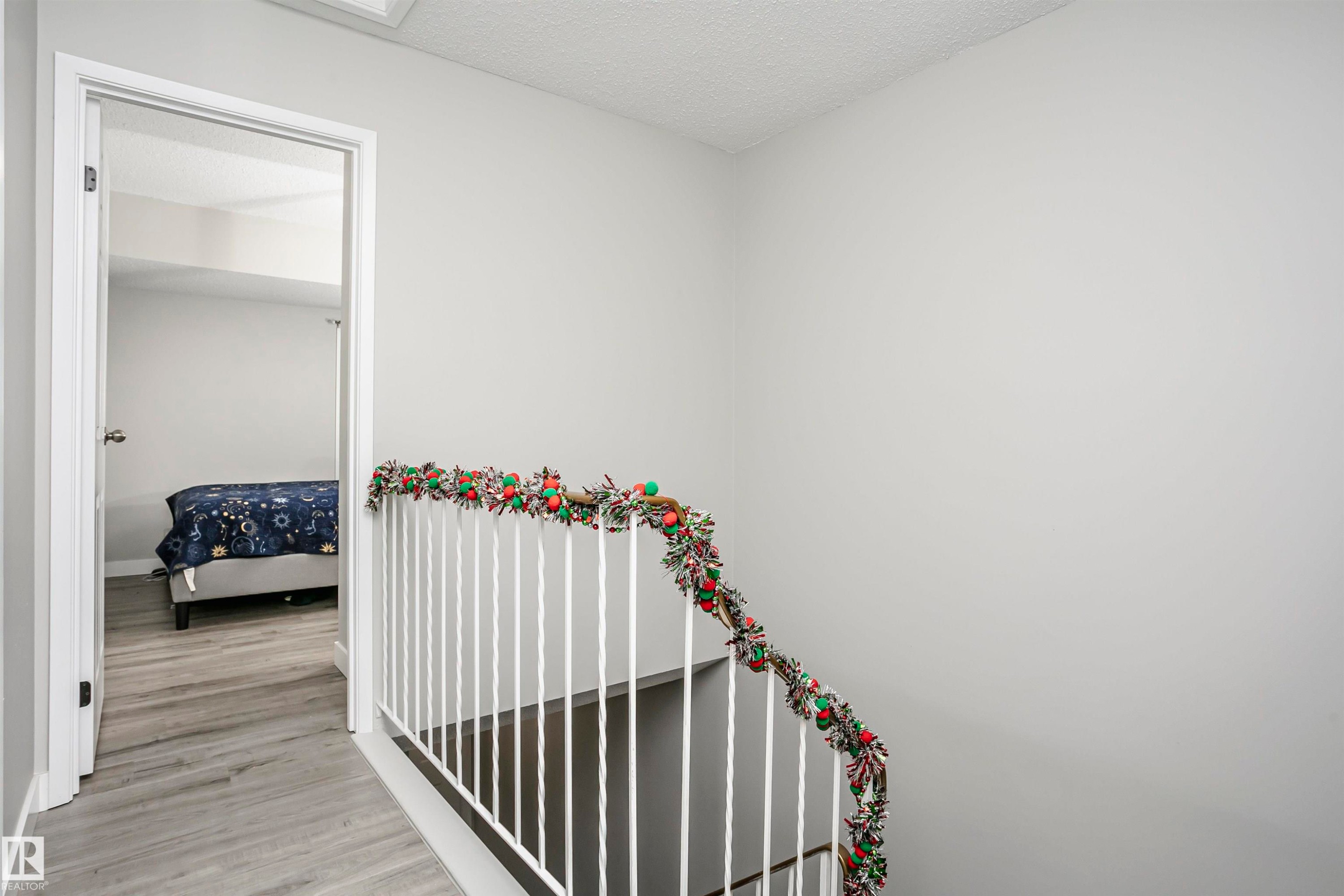 Hallway with a textured ceiling and light wood-style floors - 3103 109 Street, Edmonton, AB - Indoor Photo Showing Other Room