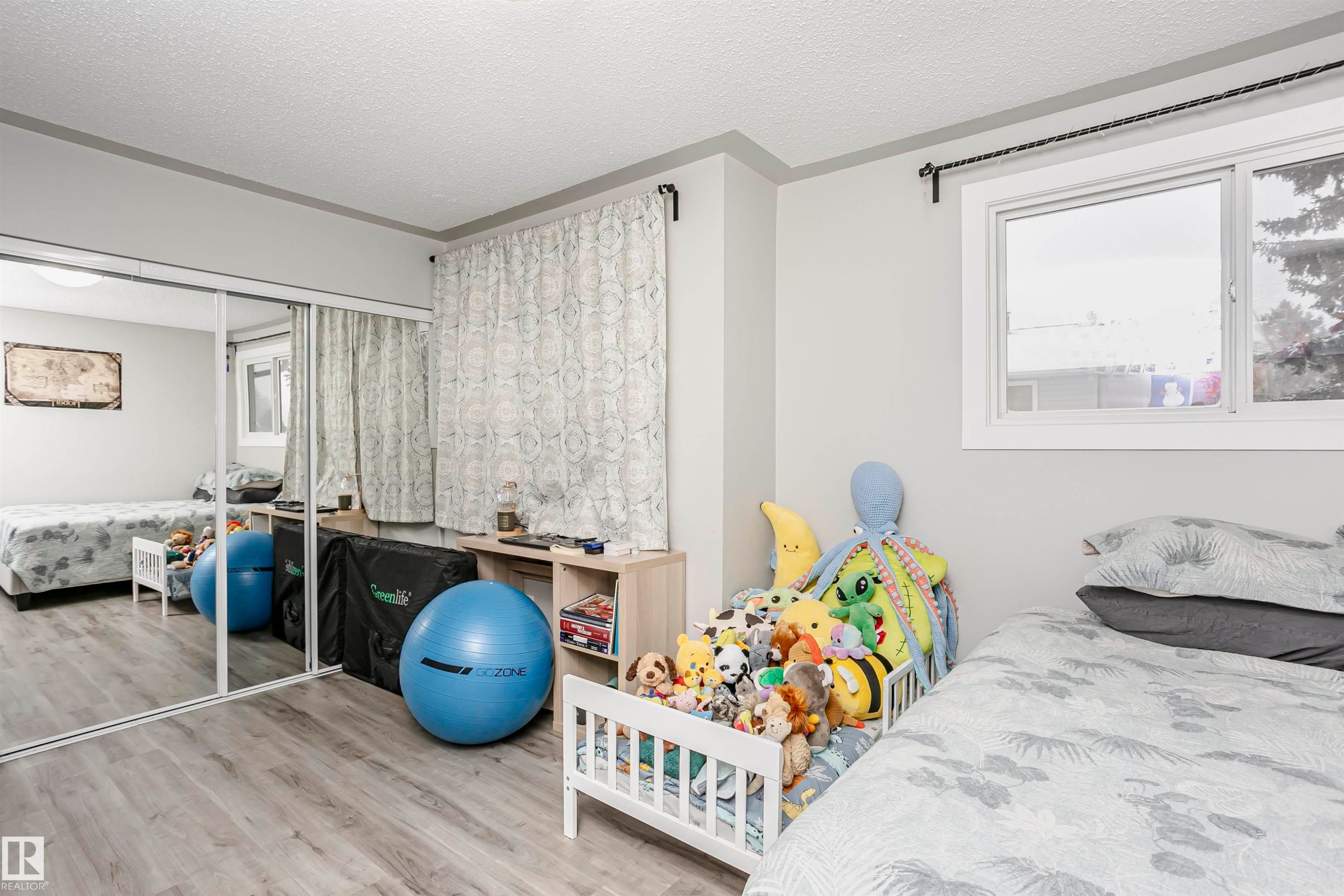 Bedroom featuring a textured ceiling, wood finished floors, and a closet - 3103 109 Street, Edmonton, AB - Indoor Photo Showing Bedroom