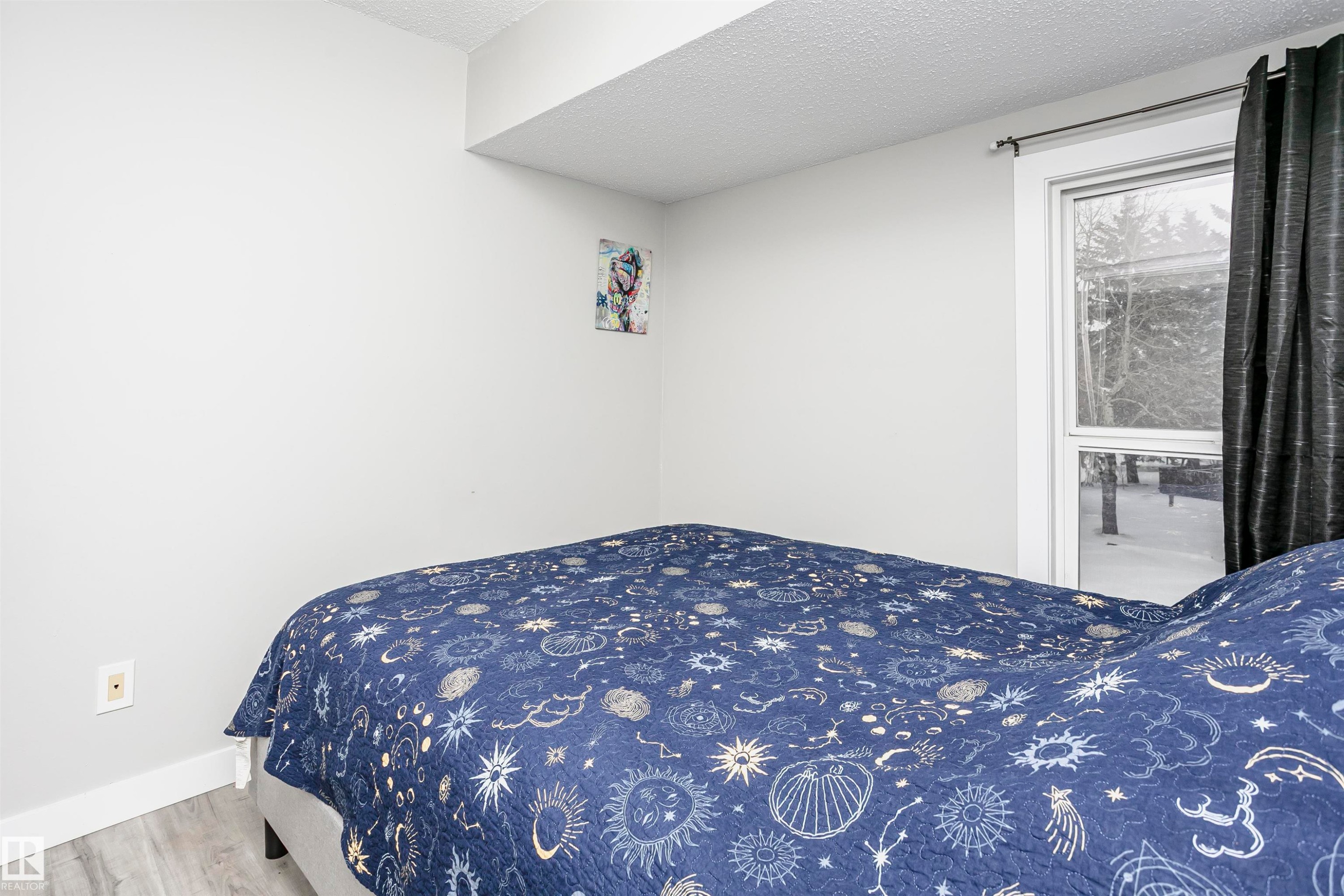 Bedroom featuring a textured ceiling and wood finished floors - 3103 109 Street, Edmonton, AB - Indoor Photo Showing Bedroom