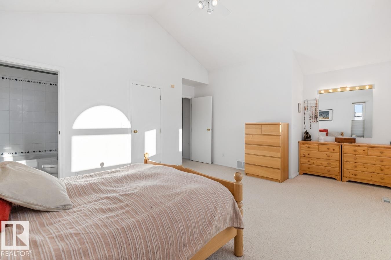 Bedroom featuring carpet flooring, ensuite bathroom, and high vaulted ceiling - 6508 109 Avenue, Edmonton, AB - Indoor Photo Showing Bedroom