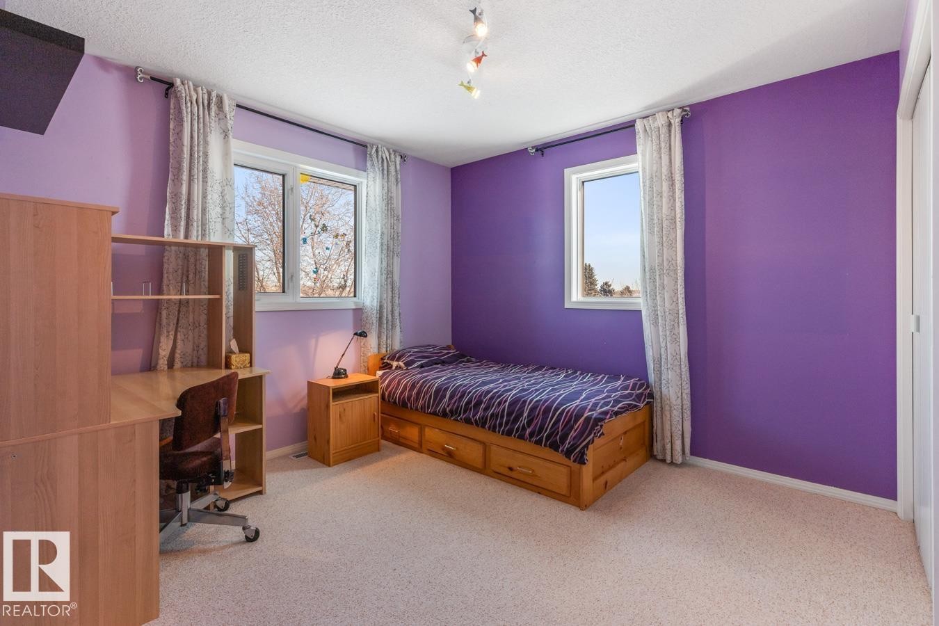 Bedroom with carpet floors, a textured ceiling, and an office area - 6508 109 Avenue, Edmonton, AB - Indoor Photo Showing Bedroom