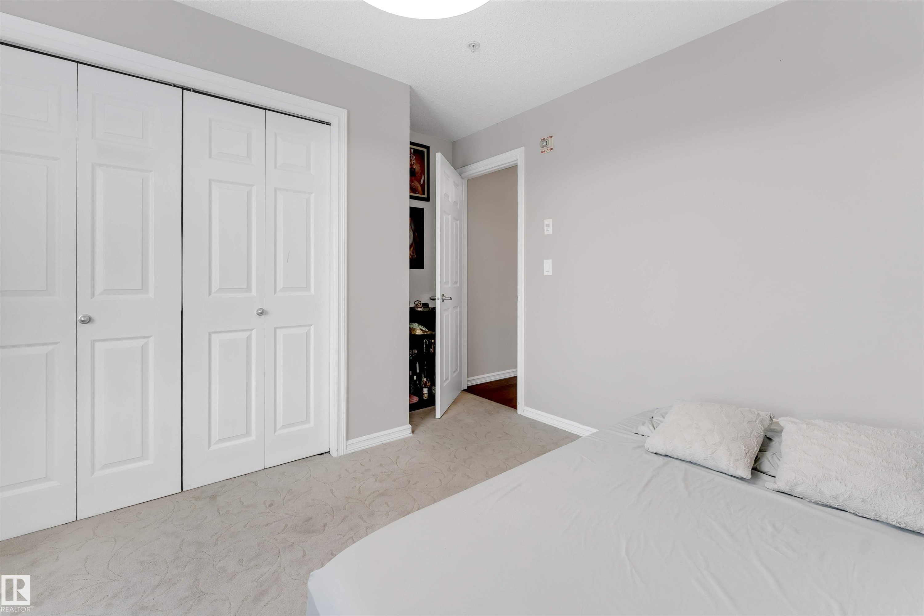 Bedroom featuring a closet and light colored carpet - #201 4403 23 Street Nw, Edmonton, AB - Indoor Photo Showing Bedroom
