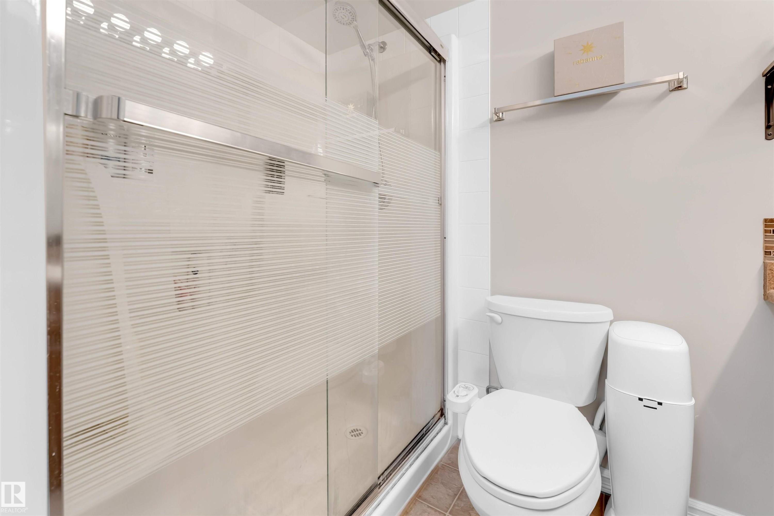 Bathroom with a stall shower and tile patterned flooring - #201 4403 23 Street Nw, Edmonton, AB - Indoor Photo Showing Bathroom