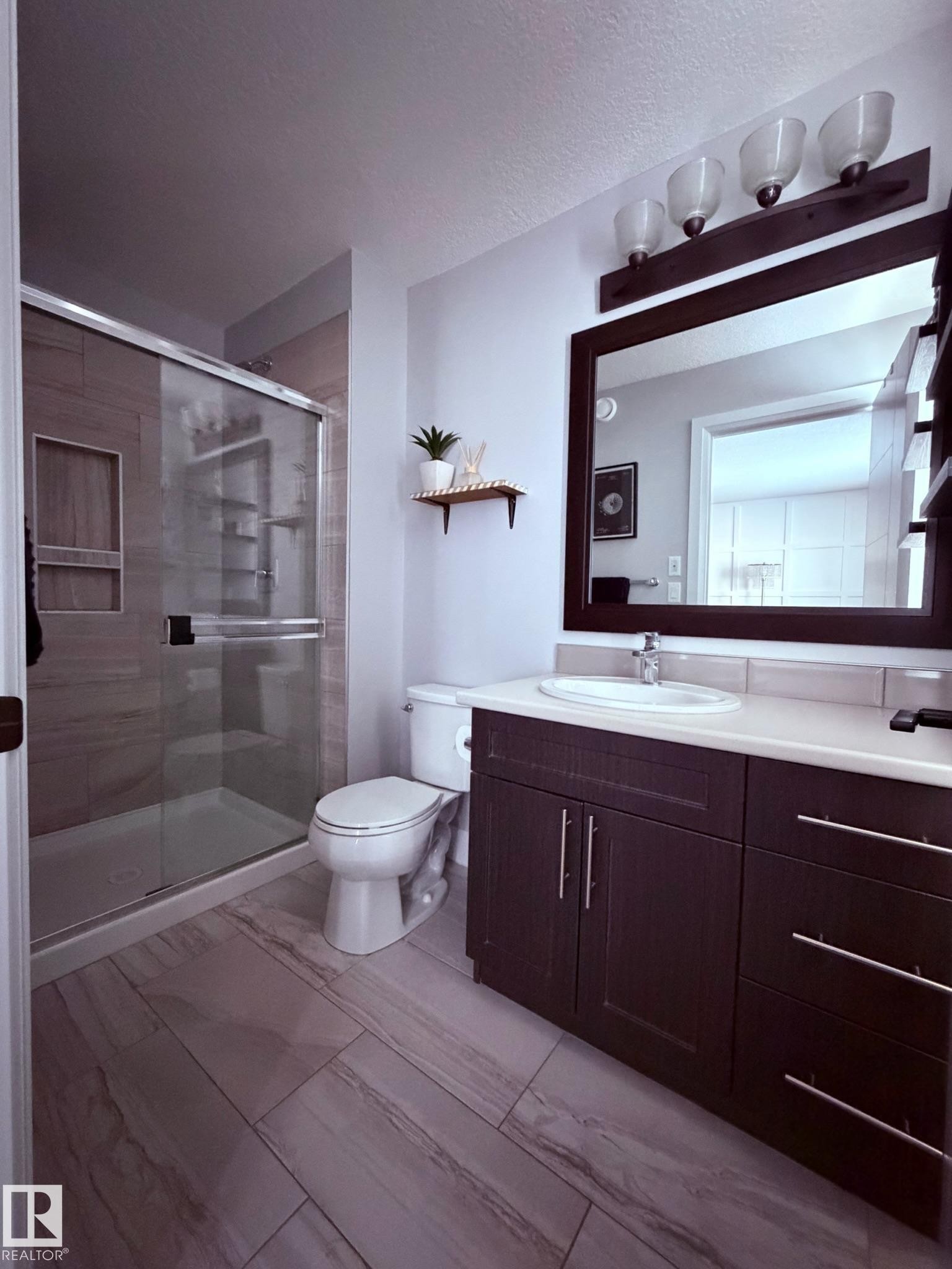 Full bath featuring vanity, a stall shower, a textured ceiling, and light marble finish floors - 25 Harrison Gate, Spruce Grove, AB - Indoor Photo Showing Bathroom