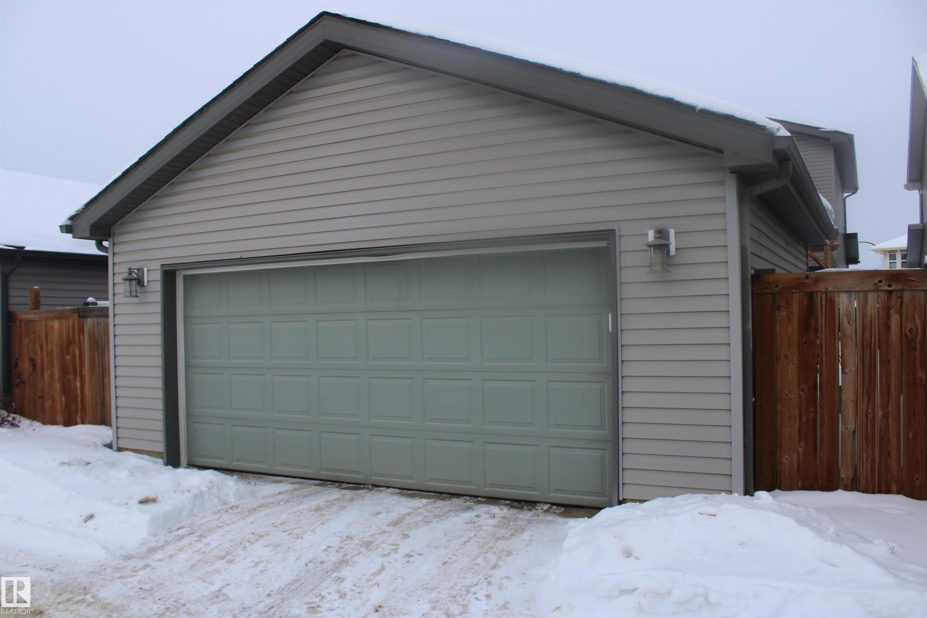 View of snow covered garage - 25 Harrison Gate, Spruce Grove, AB - Outdoor With Exterior